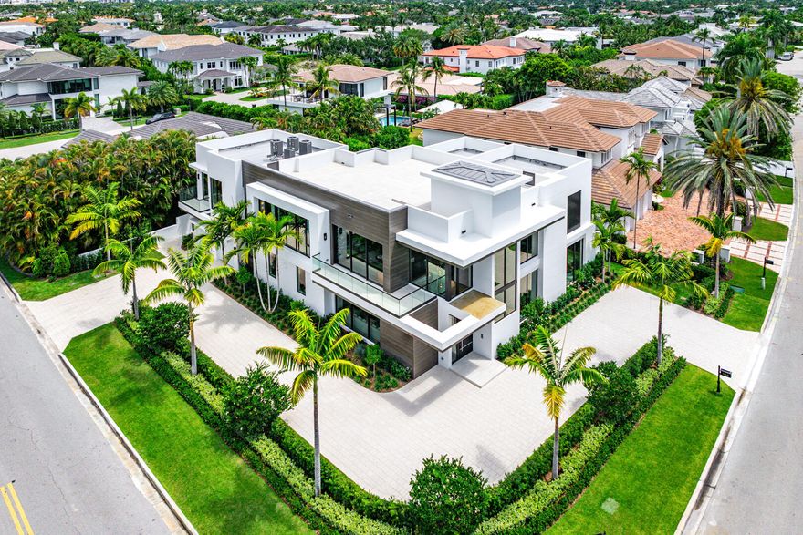 Designed by Randall Stofft Architects, built by Compson Homes, and styled by Lesly Maxwell Interiors, this residence is a modern sanctuary that blends sleek design with natural textures and bohemian influences. From the moment you enter the striking two-story foyer, expansive windows, and clean architectural lines create an inviting yet sophisticated ambiance. The great room, bathed in natural light, seamlessly connects to the covered loggia through oversized sliding doors, allowing for effortless indoor-outdoor living. A gourmet kitchen centered around a stylish eat-in island is complemented by premium stone countertops and a fully built-out pantry. The club room, complete with a wet bar, offers the perfect space for entertaining, leading directly to an outdoor terrace.    Outside, this home is an entertainer's dream. The tranquil backyard boasts a resort-style pool, spa, sun shelf, and firepit, evoking a private resort experience. A summer kitchen featuring a 36-inch stainless steel grill, refrigerator, and ice maker makes outdoor dining effortless. The lush, illuminated grounds enhance the striking modern design of this coveted corner-lot residence. Control4 smart home system automates every detail of this estate, and is masterfully curated to deliver a lifestyle of unparalleled sophistication and comfort. Buyer to pay documentary stamp taxes on the deed and title insurance.