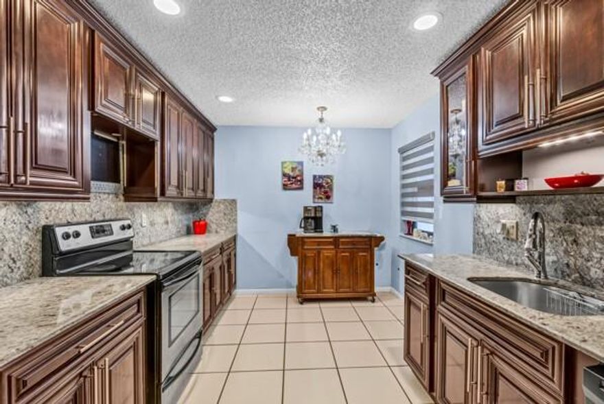 This lovely waterfront home is situated in the desirable 55+ community of Tamarind Village, which comprises only 177 detached single-family homes. The community offers a low monthly maintenance fee of $285.00, which covers cable, exterior painting, lawn maintenance, irrigation, heated pool, and clubhouse. Additionally, Tamarind Village is part of the Township, granting residents access to various amenities, including a gym, pickleball courts, tennis courts, a pool, a theater, and recreational rooms.  Three bedrooms/two bathrooms, one-car garage, enclosed patio, updated kitchen, and ceramic tile flooring. Please note that rentals are not permitted; residents must be at least 18 years old. Roof - 2017;  A/C -2014; tankless water heater. Visit this community, and you’re sure to fall in love!