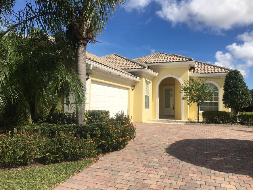 Desirable DiVosta built 3/2.5 lake front home in pristine community with full clubhouse amementies and walking distance to Tradition Square. Well maintained home with open floor plan, light colors, move in ready. Additional den, casual open kitchen with snack bar, built in entertainment center, generous closet space with built ins thru out, large laundry room with cabinets galore, central vac, paver driveway, tile roof.  Clubhouse amenities include 2 heated pools, tennis, exercise room, bocce, tennis and more.