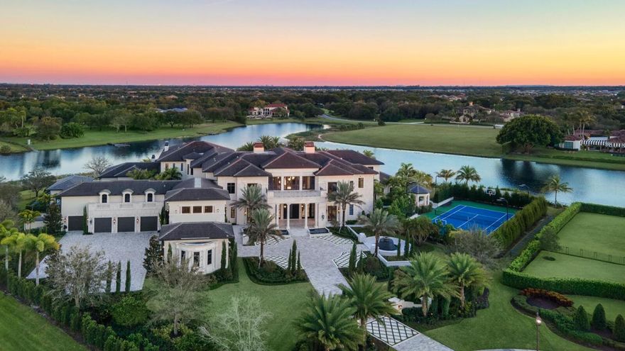 The Rockybrook Estate is an impeccable new contemporary masterpiece recognized as one of the finest properties in the United States. This custom mansion offers world-class design and lifestyle of unrivaled amenities, privacy and security. It is situated behind private gates of Stone Creek Ranch, one of the most exclusive luxury gated communities in Palm Beach County. This 31,000-square-foot architectural marvel is an ode to both modern classicism and throwback glamour. In the same breath, the inviting seven-bedroom, 11-full-bath layout captivates with family friendly flourishes that double as entertainment spaces. It's the best of all worlds—sophisticated design, jaw-dropping detail and tangible warmth, flawlessly executed under one roof. Rockybrook dazzles at first dramatic sight with a grand foyer and custom-designed open-arms staircase that recalls a scene from a Hollywood classic. It's a hint at what's to come - one space after another that stirs the senses. A stately living room with marble flooring and 32-foot walls. A dining room that seats 16 with white agate backlit walls and white mother-of-pearl ceiling treatment. A glass-encased, temperature-controlled wine room. A Zen-like garden area with a waterfall treatment and koi pond. Original lighting fixtures by the likes of artists Dale Chihuly and Nicolas Terrain. A long hallway off the foyer eventually leads to a gourmet Downsview kitchen with state-of-the-art appliances; a striking double-column, stainless-steel range hood; and a separate island counter with seating for six and playfully oversized lighting. And that's not even the only place to prepare mealsRockybrook also boasts a separate commercial catering kitchen.
Upstairs, the master bedroom has its own separate wing, including a study lounge and kitchenette. The main balcony of the suite features a fireplace, whirlpool bath and sun deck, all overlooking the property's lush 2.5 acres and unrivaled outdoor spaces. Exquisite details also abound in the master baths; hers is adorned with amethyst and boasts a center bathtub with a hanging crystal chandelierand both baths have their own balconies. 
For all of its eye-catching opulence, Rockybrook also manages to enchant with a resort-like vibe that makes every day feel like a getaway. Look no further than the 250,000-gallon heated pool with black mosaic glass waterline tile and a black Pebble Tec finish, an ode to the infinity-edge splendor at Wynn Las Vegas. The tropically landscaped pool areacomplete with waterfalls, fire pits, a covered pavilion and dining area, a grotto with a rain feature, and a fully equipped summer kitchenprovides an entertainment epicenter for all seasons. But that's hardly the only place to play at Rockybrook.
The estate also features a club room with a bar, card table and billiards table; a cigar room; a cinema-style theater roomand even a two-lane bowling alley in the massive children's lounge. Rockybrook also sports health and beauty areas, including a spa treatment room, salon, gym and sauna, a championship tennis court, and a blissful meditation space overlooking the tropical garden. 
The residence also is designed with hurricane-resistant windows, doors and exterior construction. In addition, it comes with a Creston smart home system and security cameras. As seen on CNBC, The Rockybrook Estate is truly a sight to behold and will appeal to the most discerning of tastes.