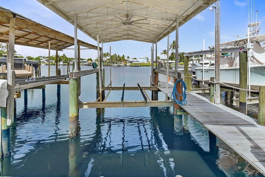 Buyer's financing fell through!  You have another shot at this WATERFRONT PARADISE WITH OCEAN ACCESS AND NO FIXED BRIDGES!  This gem is ideal for Boaters & RV Enthusiasts! Welcome to your South Florida coastal retreat! Perfectly situated on a premium corner lot with direct ocean access and no fixed bridges, this stunning CBS home offers 4 spacious bedrooms, 2 updated baths, and a 2-car garage. Meticulously designed for both comfort and entertainment, the property boasts a screen-enclosed pool and expansive patio, seamlessly blending indoor and outdoor living. Boating enthusiasts will appreciate the private dock with lift, full electric and water hook-ups, while RV owners will find the rebar-reinforced driveway with dedicated A-Class RV parking, complete with electric service, a rare and invaluable feature. The circular drive provides ample guest parking for effortless entertaining.  The backyard is a true tropical oasis, featuring a lovely waterfall feature on your pool, along with a custom tiki bar, two outdoor kitchenettes, fruiting mango trees, and a wired 220V shed perfect for hobbies or storage. Inside, you'll find solid construction, a designated safe room, and thoughtful upgrades throughout. With no HOA restrictions, enjoy the freedom to live your waterfront lifestyle without compromise.  This one-of-a-kind property combines privacy, convenience, and luxury just minutes to open water, all while being a storm hideaway for your boat.  An exceptional opportunity for discerning buyers seeking an entertainer's dream home with unparalleled boating and RV accommodations.  Waterfront living with direct ocean access and no fixed bridges in the heart of Port St. Lucie.  No HOA restrictions. Easy access to shopping, dining, and major roadways while enjoying peaceful waterfront privacy. A rare opportunity to own a true boater's retreat where your home doubles as your marina.  INSPECTION REPORT STATES THAT THERE ARE 17 YEARS OF LIFE REMAINING ON THE ROOF! Schedule your private showing today and start living the lifestyle you and your toys can get accustomed to!