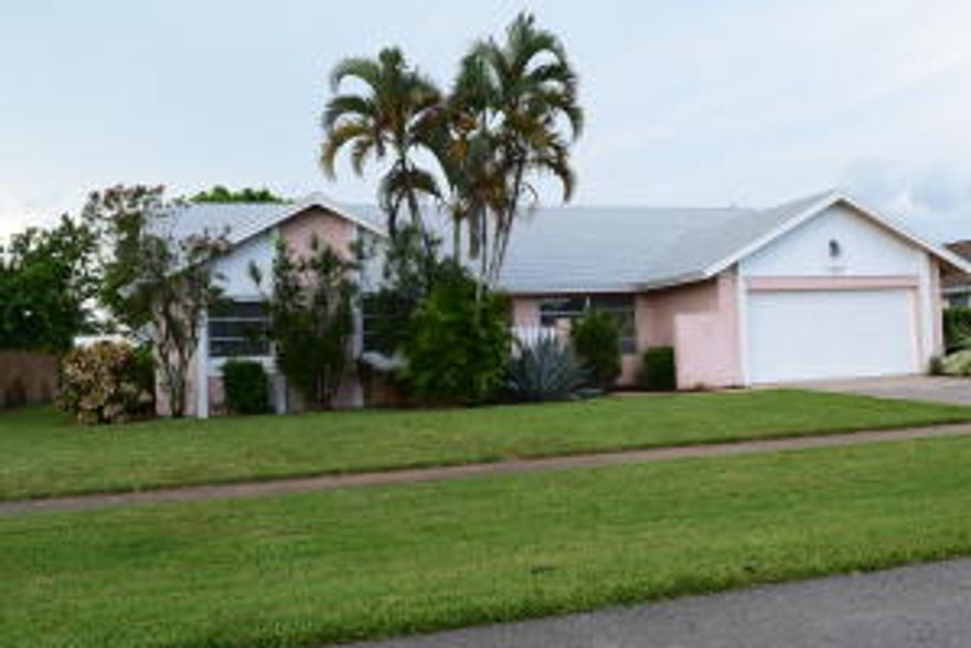 Splashing Different, refresh yourself in this four bedroom, two full bathroom home complete with incredible screened in-ground pool. You'll enjoy everything Florida has to offer relaxing by your pool overlooking a serene canal front fenced in lot. Spoil yourself in 2080sq ft of living area, with tile floors thru-out, enjoy the view from from a large kitchen, breakfast area and family room.This home boast a well thought of floor plan and flow with roomy bedrooms, a large family room with cathedral ceilings, formal dining room and separate living room all this is great for entertainment. Other features are laundry room, step-down shower in master bathroom, large two car garage all nestled on a large tropical setting very convenient to Schools and Wellington Green Mall.