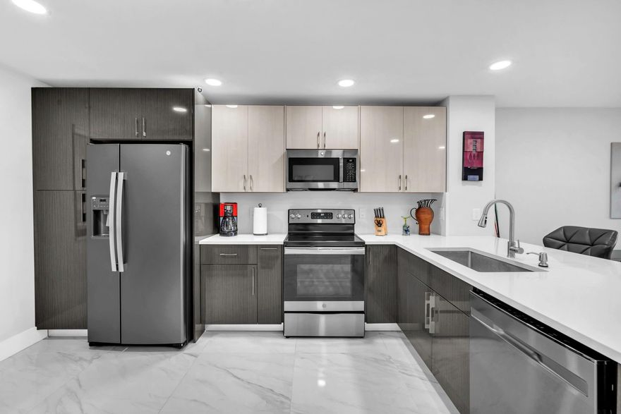 Impeccably renovated corner condo showcasing exceptional luxury, craftsmanship, and attention to detail no expense spared. A refined neutral palette, skim-coated ceilings, recessed lighting, and seamless 32" marble style tile create a timeless, modern feel throughout. Impact windows and doors, high quality finish trim, shaker panel doors, custom closets, and blackout cellular shades elevate every space. Spa inspired baths feature frameless silver sliding shower doors, while the Italian-designed kitchen offers a sleek layout with stainless steel appliances. Enjoy serene Cypress Island lagoon views and stunning Florida sunsets. Pet-friendly, all ages welcome, close to shopping and entertainment, and just 6 miles to the beach. A truly move in ready gem.