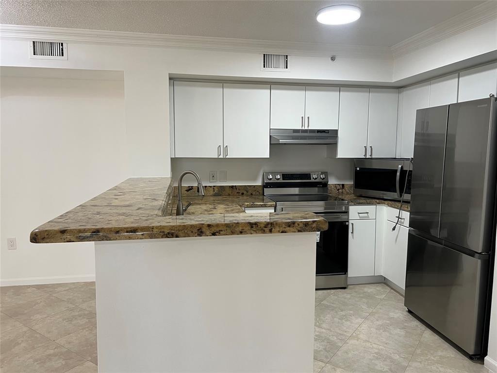 !!!!TOTALLY REMODELED FIRST FLOOR UNIT,NEW STAINLESS STEEL KITCHEN APPLIANCES,FRESHLY PAINTED INTERIOR,A/C APPROX 1 YEAR OLD,NEW LIGHT FIXTURES,NEW WASHER AND DRYER,NEW VANITIES IN BOTH BATHROOMS,NEW VINYL TILE IN BOTH BATHROOMS,NEW CLOSET SHELVING IN ALL CLOSETS,NEW WINDOW BLINDS,HURRICANE SHUTTERS,ALL GROUT PROFESSIONALLY CLEANED,NEW GARBAGE DISPOSAL,PATIO AND WINDOWS PRESSURE CLEANED,(HURRY THIS PROPERTY WILL NOT LAST)