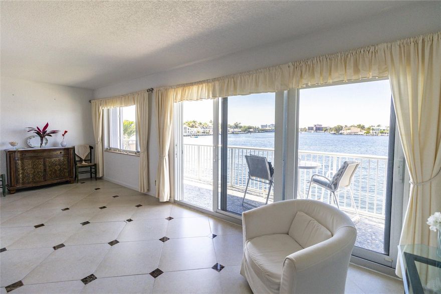 It’s all about the view. This bright and spacious 1-bedroom, 1-bath residence sits directly on a wide canal with beautiful open water scenery from the moment you walk in. Water and sky fill the living space, creating a calm, coastal atmosphere buyers love.Impact glass doors open to a private waterfront balcony finished with elegant pebbled marble tile—the perfect place to relax and enjoy the view, day or evening. Extra windows in the dining areas bring in abundant natural light and keep the water in sight from multiple angles. Updated kitchen with white shaker cabinets.Well maintained and move-in ready, you can enjoy it immediately—or rent it out right away. Rare waterfront flexibility makes this a standout opportunity.