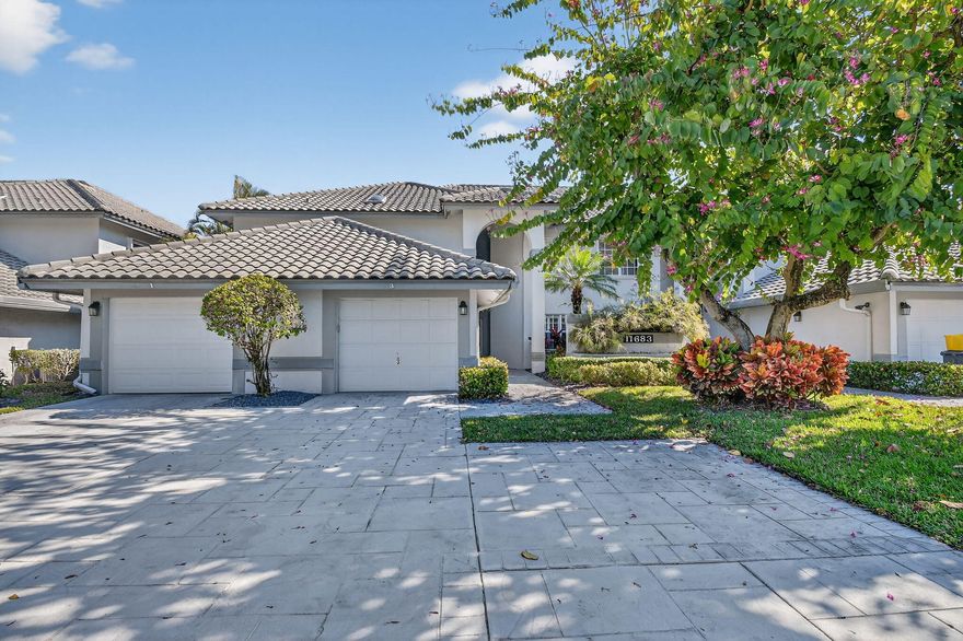 Lovely 2 bedroom, 2 bath residence with soaring vaulted ceilings and peaceful water views, located in the desirable Briarwood community at Indian Spring, a non-mandatory Country Club. Enjoy tranquil mornings and relaxing evenings from your enclosed balcony with preferred eastern exposure. The split-bedroom floor plan offers ideal privacy for guests, while the spacious eat-in kitchen features plenty of cabinetry and a large pantry. A full-size washer and dryer add everyday convenience, and both bathrooms have been beautifully updated with stylish finishes. Ideally situated just minutes from shopping, dining, golf courses, and pristine beaches, this home offers the perfect blend of comfort, space, and convenience in a resort-style setting. Briarwood at Indian Spring provides residents with access to pools, a clubhouse, and a variety of social activities in a secure and vibrant 55+ community. Don't miss this opportunity to enjoy the best of the South Florida lifestyle.