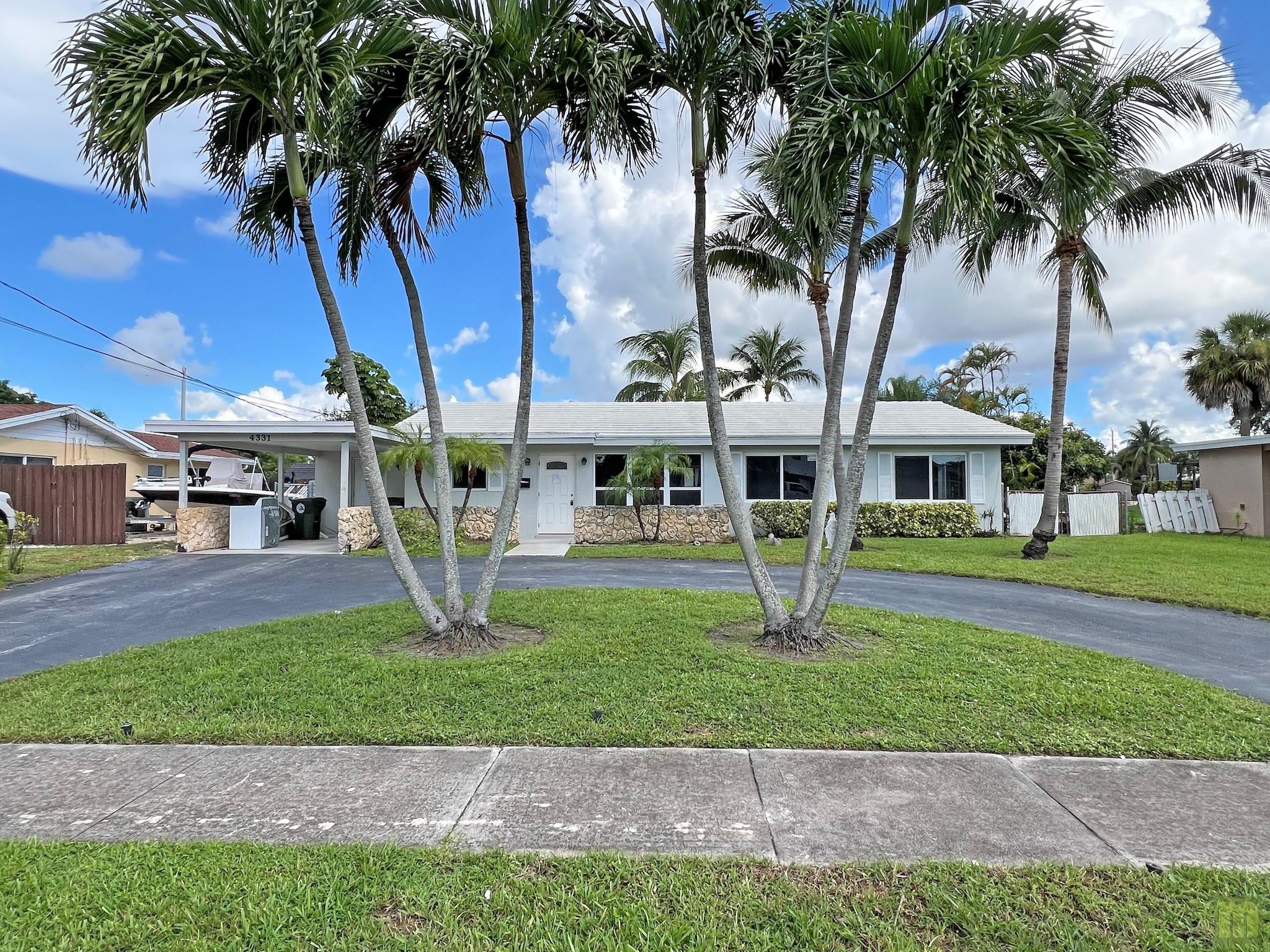 FRESHLY RENOVATED with a gorgeous BRAND NEW kitchen with white shaker cabinets, quartz countertops and stainless steel appliances. Beautiful, new tile flooring throughout, updated bathrooms, new impact windows and doors. Three bedrooms with an en-suite primary and two more roomy guest bedrooms. Spacious floor plan and a large fully-enclosed Florida room overlooking the pool and Lake Julie. Located in the quiet NO HOA neighborhood of South Creek, this lovely home is close by schools, shopping, the Florida Turnpike and just 7 miles to the beach. Be the first to live in the remodeled gem!!!! Available for showings soon - this one will not last!!!!!