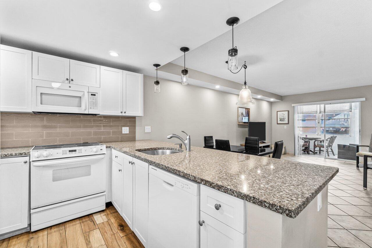 Updated ground-floor 2 bed, 2 bath corner unit in 55+ Village Royale--perfect for a seasonal escape or full-time Florida living! Prime Boynton Beach locale minutes to the beach, Publix, shopping, dining, I-95 & close to airports. This move-in ready home boasts an open floor plan, white kitchen cabinetry & granite countertops with views to the dining, living & Florida room. The versatile FL room offers space for an office, den or gym & includes an in-unit W/D. Generously-sized primary suite & guest bedroom with ample closet storage; guest bath recently remodeled. Assigned parking + guest spaces. HOA includes water, trash, sewer, cable & internet & amenities such as a clubhouse, pool, library, shuffleboard, BBQ & more.Seller to pay known, existing special assessments.