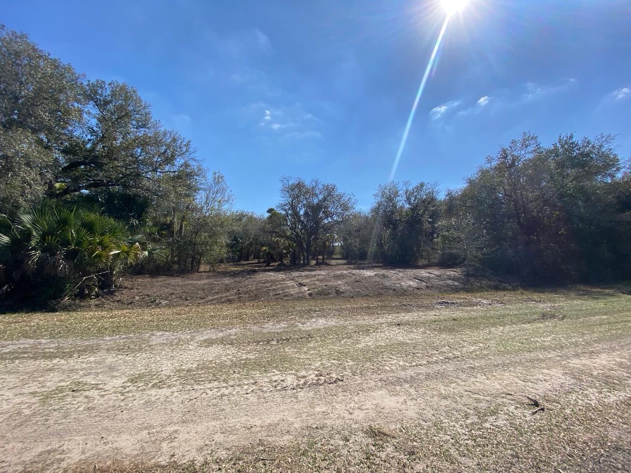 Your Haven Awaits! This 1.5 acre lot is High and Dry! Mature oaks line the property which has been cleared and made walkable. This lot is able to be zoned for either a single family residential or a mobile home. The property is being sold with a boundary survey from March 2024. Whether you plan to build or simply camp on the weekends, the possibilities are endless. Approx. 3mi from Kissimmee Prairie Preserve State Park. An hour to Vero / Saint Lucie / Sebring and about 30 minutes from shopping and dining in Okeechobee.