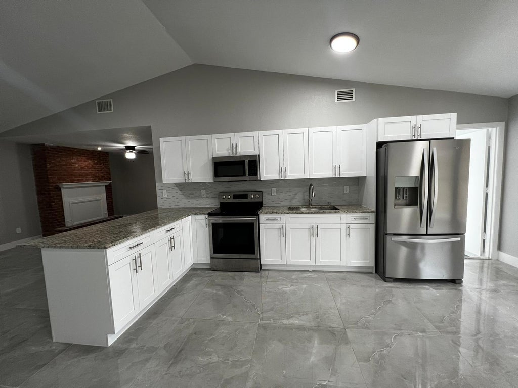 Photo of 1310 SW Bellevue Avenue, Port Saint Lucie, FL 34953 (MLS # B26066746)