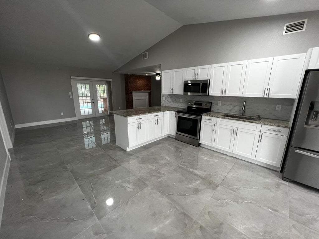 Photo of 1310 SW Bellevue Avenue, Port Saint Lucie, FL 34953 (MLS # B26066746)