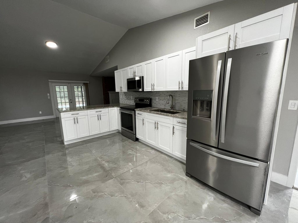 Photo of 1310 SW Bellevue Avenue, Port Saint Lucie, FL 34953 (MLS # B26066746)