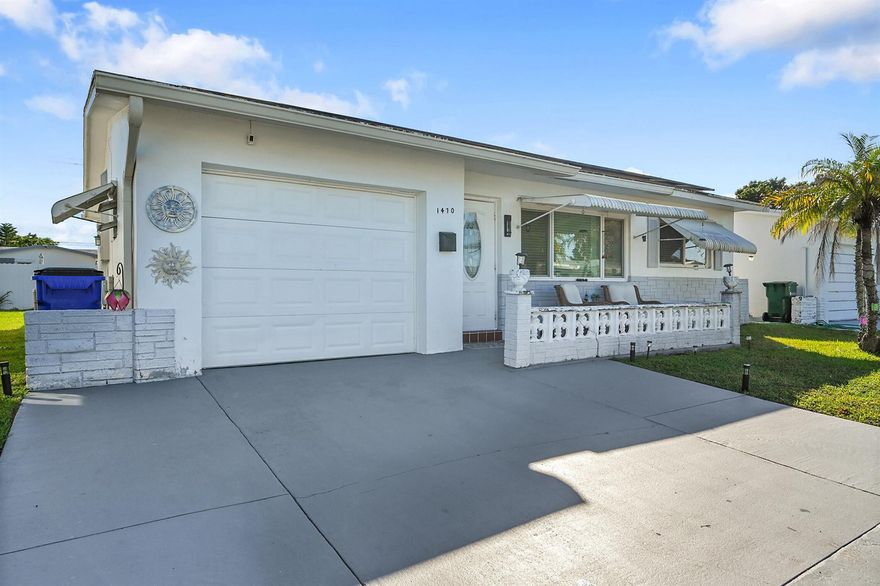 Located in the desirable 55 plus community of Paradise Gardens II, this updated single family home offers a bright, spacious setting with an inviting open concept design. The neighborhood is known for its peaceful surroundings, natural green spaces, and canals, along with a variety of amenities that include a heated pool, clubhouse, game room, and space to enjoy the Florida lifestyle. Inside, the home provides approximately 1,121 square feet of living area with two bedrooms, two full baths, and a single car garage equipped with a washer and dryer. The kitchen features white cabinetry, a generous island, granite countertops, and stainless steel appliances. An enclosed sunroom offers extra room for relaxation, and the backyard adds a nice outdoor touch. Low quarterly HOA.