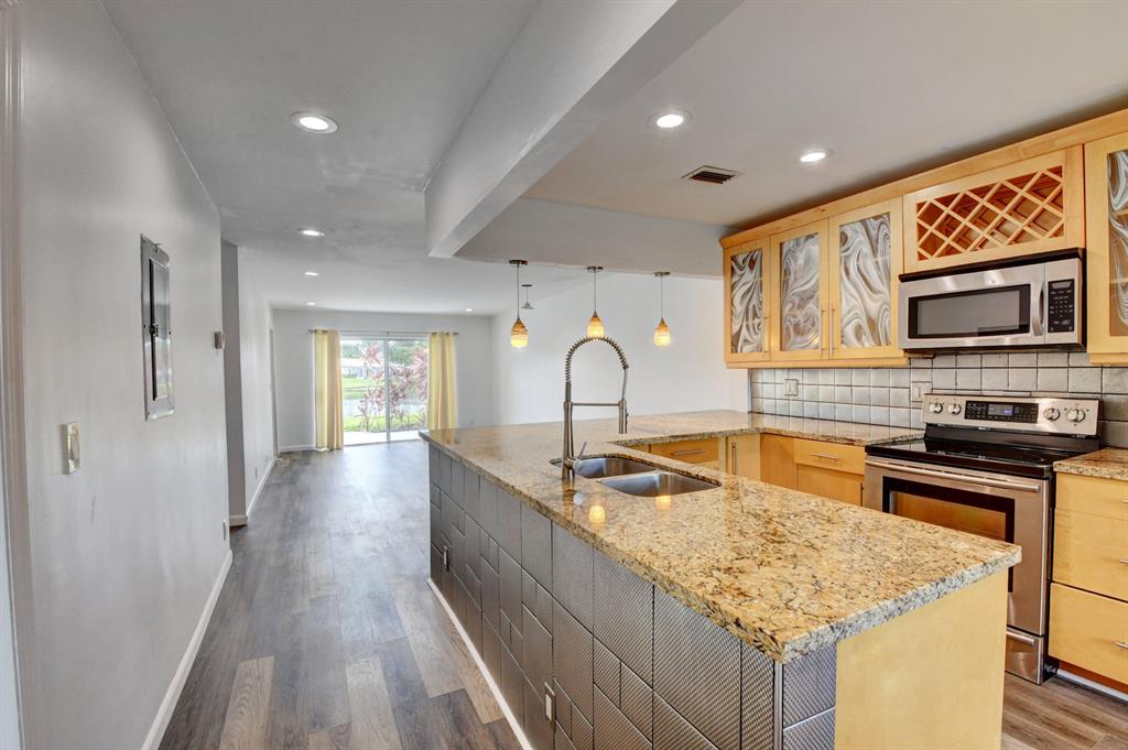 Beautiful one story villa in sought-after lake location. Boca Lakes is a 55 and older gated community with easy access to the turnpike and all of the new shopping/restaurants on Glades. New floors, new A/C. Second bedroom has a built-in Murphy bed perfect for guests. Gorgeous clubhouse area with heated pool, tennis courts, bocce and more.