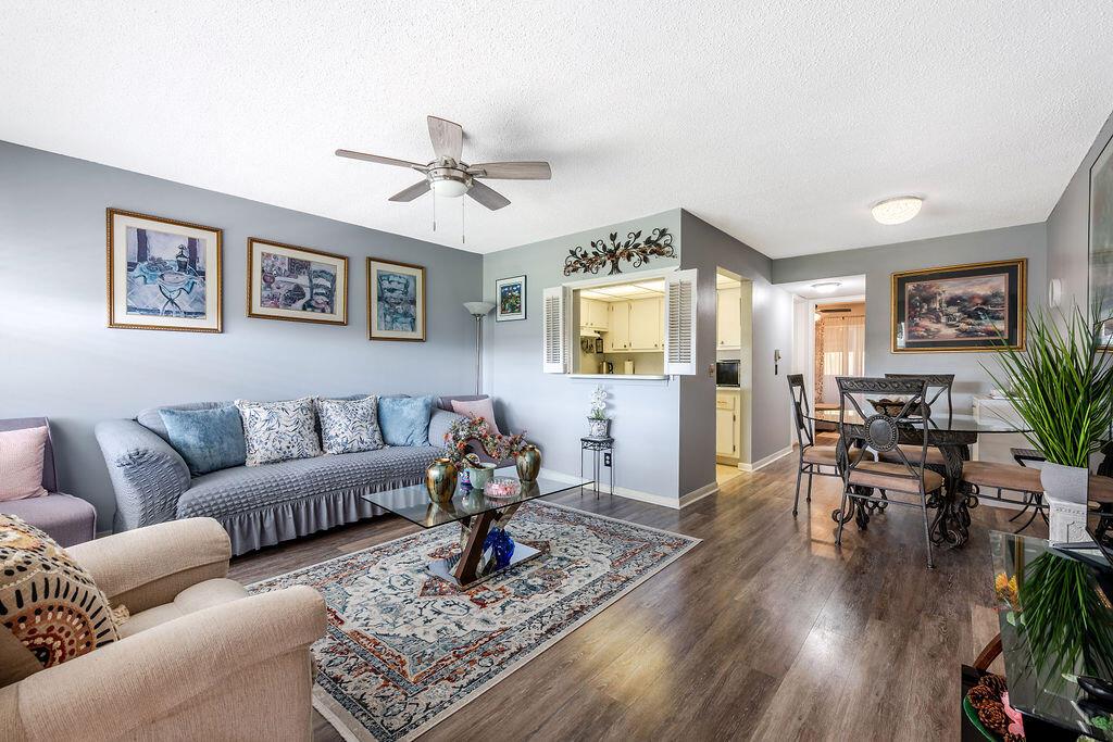 Welcome to this well-maintained second-floor condo in the sought-after gated community of Century Village in West Palm Beach. This light-filled 1-bedroom, 1-bath unit offers a comfortable and convenient lifestyle with 24/7 security. Enjoy the ease of access to nearby amenities--just a short walk to the pool, laundry facilities, and a private storage room. The condo features a kitchen with a passthrough to the living area, a large pantry, and durable laminate flooring throughout. The spacious bedroom offers generous closet space, while the screened-in patio provides a peaceful spot to relax.