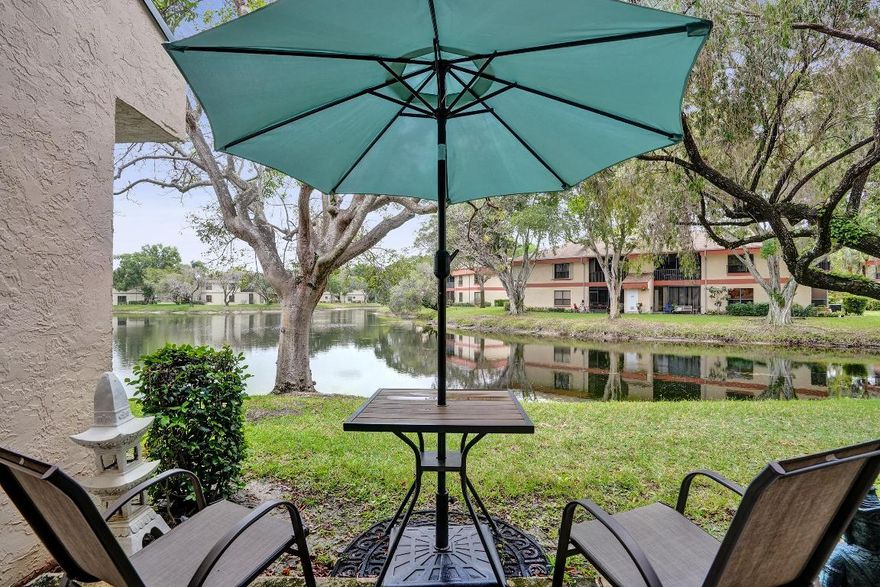 Welcome to the Township of Coconut Creek. This gorgeous move in ready 3/2 lake front 1st floor condo can be yours! Impact windows throughout, newer AC (2022), newer roof, Impact windows and sliders. New Accordian Shutters.  The balcony has been closed in with impact sliders to add a Florida / dining room creating over 300 additional sq.ft. to the unit. Beautiful lake views from almost every room. Granite counter tops, newer white shaker cabinets and stainless steel appliances in the kitchen. Tile floors throughout, no carpet!  Washer and dryer in unit. This community has amazing amenities, clubhouse, fitness center, pools, basketball court. Close to everything, South Florida has to offer