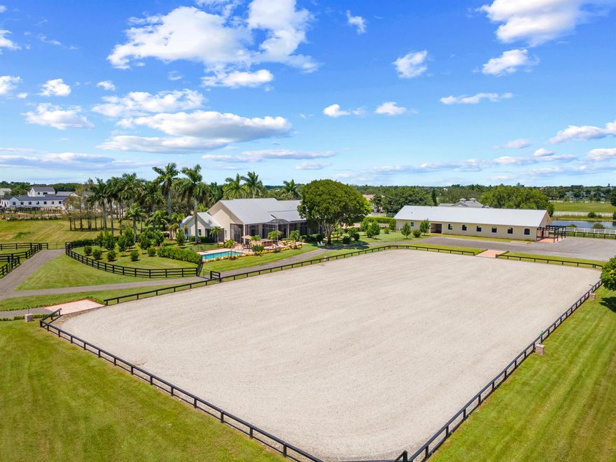 Great location close to the horse show grounds, within the elite gated community of Palm Beach Point. Recently completed, this  farm is ready for the upcoming season. New 12 stall center aisle barn by 5 Star Builders features a full wood tongue and groove ceiling, a 2-bedroom 2 bath staff quarters, feed and tack rooms, plus a 1/2 bath and Laundry, and is conveniently accessed by a separate entrance. A new all-weather arena with fiber footing, and six fenced and irrigated paddocks complete the equestrian facilities. Recently renovated the 5-bedroom 5 bath home features a new pool and outdoor grill area.  This ready to go farm sits on a roomy 6.4 AC lot at the end of a street, with a short walk to the horse show grounds. The mature landscape and lovely metal roofs on both house and barn, add