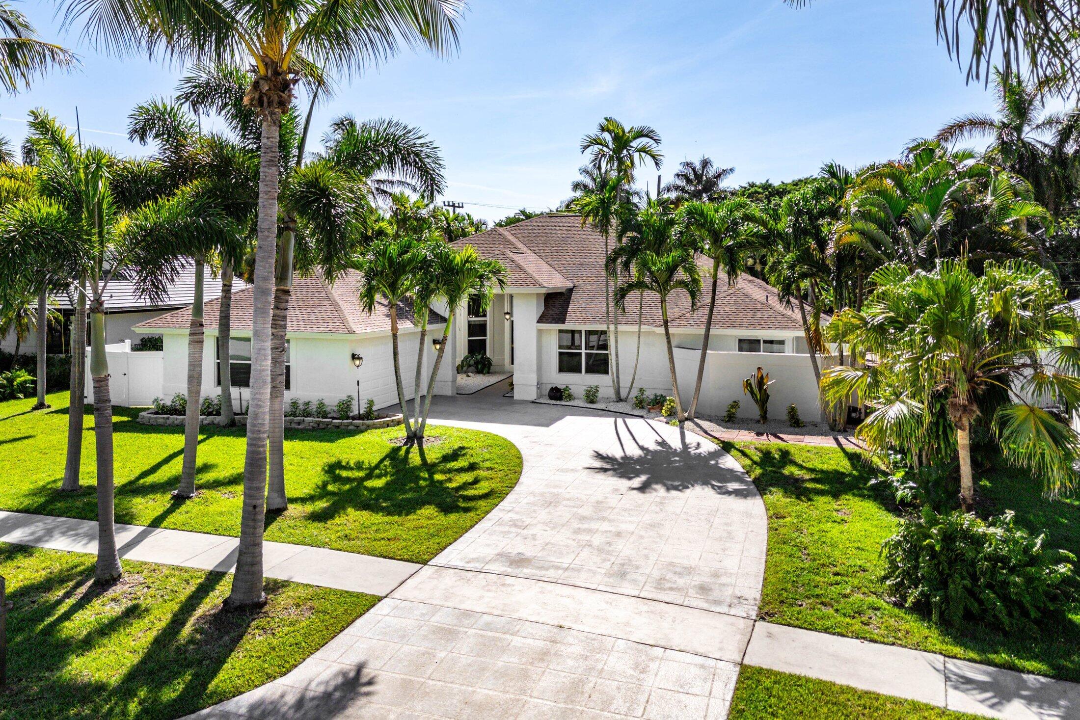 Nestled in the heart of Boca Raton's prestigious Hidden Valley community, 7700 Fairway Trail presents a striking single-family home poised to capture attention immediately. Recently updated, this single-story residence with over 2,600 AC sqft shines with new flooring and a modern kitchen, framed by soaring ceilings and hurricane-impact windows and sliders that flood the living and family rooms with natural light. Offering 4 bedrooms and 2.5 baths, the layout is thoughtfully crafted: the primary suite and adjacent office/bedroom share a large bath, while the opposite wing mirrors that amenity with another shared bathroom.Outside, a breathtaking entertainer's paradise awaitsa"with a large covered patio and updated saltwater pool surrounded by lush landscaping.