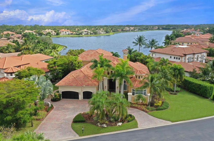 Panoramic water views from almost every room in this 5 bedroom, 6 full and 2 half bath one-of-a-kind custom estate home in desirable Mirasol.  Downstairs open floor plan with long lake views begin as you enter through a high ceilinged foyer that flows into an impressive living room with fireplace, dining room, wet bar, family room, kitchen, butler's pantry  and  breakfast area.  The newly installed custom kitchen has quartz countertops, decorator designed cabinetry, two sinks, two dishwashers and Viking, Bosch and Subzero appliances.  Additional downstairs features include Robert Abbey and Corbett light fixtures, coffered ceilings, powder room and marble flooring.  The main floor continues with a luxurious master suite with a sitting area overlooking the water from the wrap around...