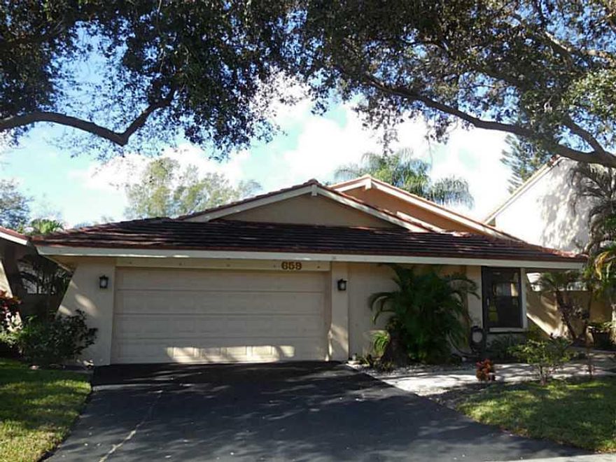 Beautiful patio home with magnificent golf course views! Enjoy relaxing on your new roofed and screen enclosed patio, and watching the gorgeous Florida sunsets. Third bedroom is currently used as an office/den, but could be converted back to a bedroom if  desired. All popcorn has been removed from the ceilings, lovely crown molding. Updated kitchen, tile throughout living areas, and hard wood floors in master bedroom and den. Hurricane shutters. Electric panel was replaced. Just over 3 miles to the beach!