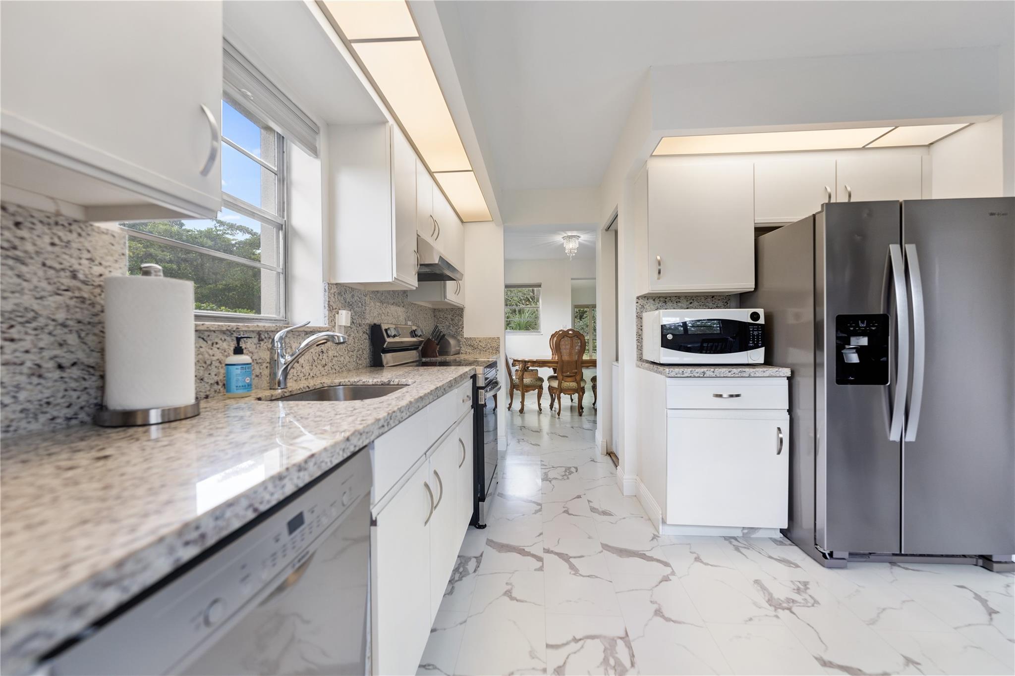 This updated private corner unit is surrounded by natural light and lush trees, offering a serene and quiet escape. The spacious layout boasts modern finishes and newer appliances, perfect for relaxation or entertaining. Just steps from the main pool, this one-of-a-kind home is unmatched in charm and convenience.
Enjoy unparalleled amenities, including a sparkling pool, pickleball and tennis courts, a billiards hall, a golf course, a gym, a theater for live performances and a restaurant. An on-site physician's office provides added peace of mind! Just minutes from Publix, Wynmoor combines tranquility with an active lifestyle. Don’t miss this rare opportunity to own a truly exceptional unit. Schedule your private tour today and experience the extraordinary living Wynmoor has to offer!