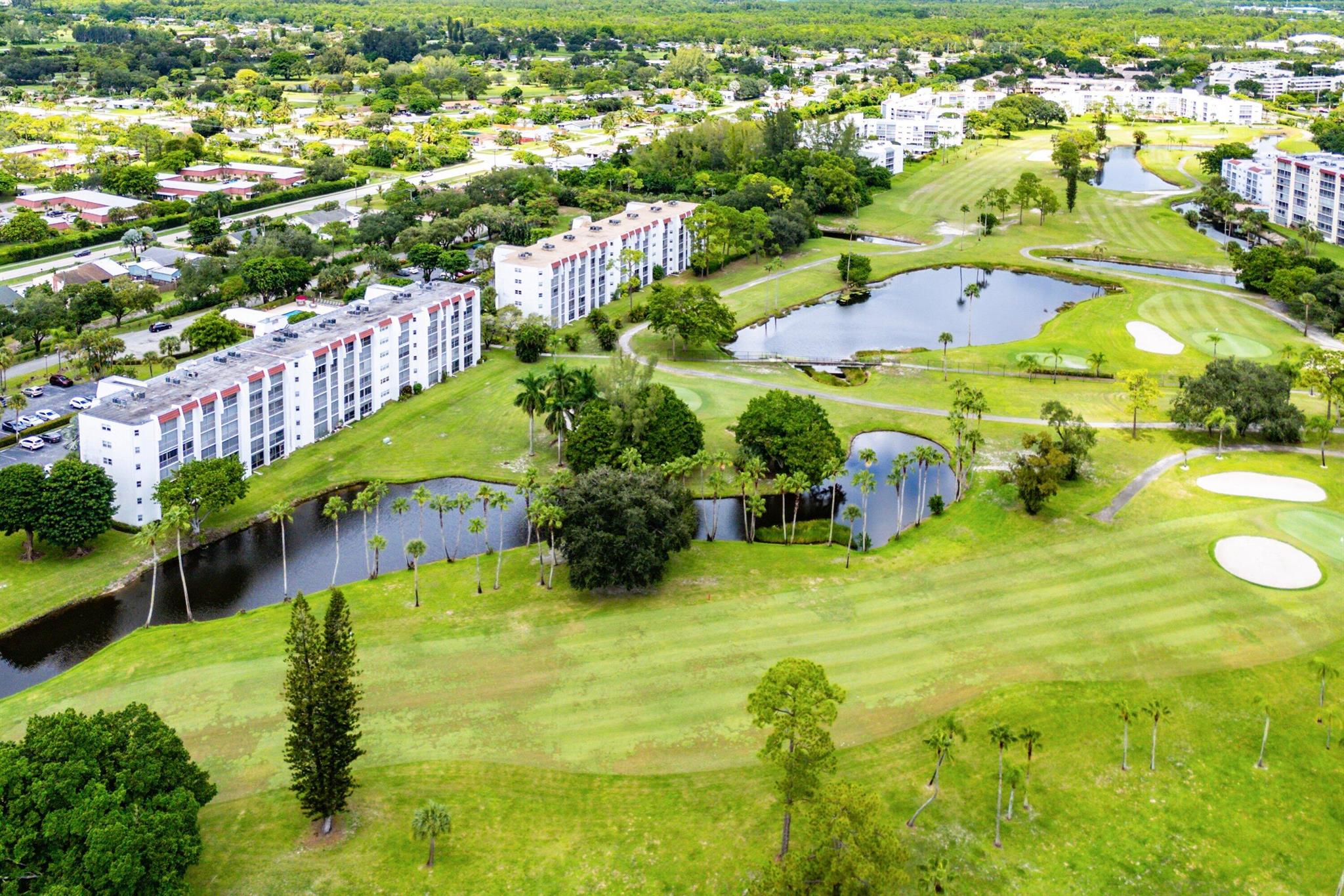 Welcome home to this beautifully updated two-bedroom, two-bathroom condo with stunning lake and golf course views in the highly desirable Birdie Drive of Poinciana. Perfectly positioned for extra privacy and just steps from the pool, this residence combines comfort, convenience, and resort-style living. With elevator access and a thoughtfully designed layout, it's truly a rare find.Inside, you'll find diagonally laid tile flooring throughout the main living areas, enhanced by updated trim, fixtures, fresh paint, and an abundance of natural light. The fully remodeled kitchen features modern solid wood shaker cabinetry with soft-close hinges, marble countertops, all white subway tile backsplash, new GE appliances, and upgraded fixtures and hardware.The open living and dining
