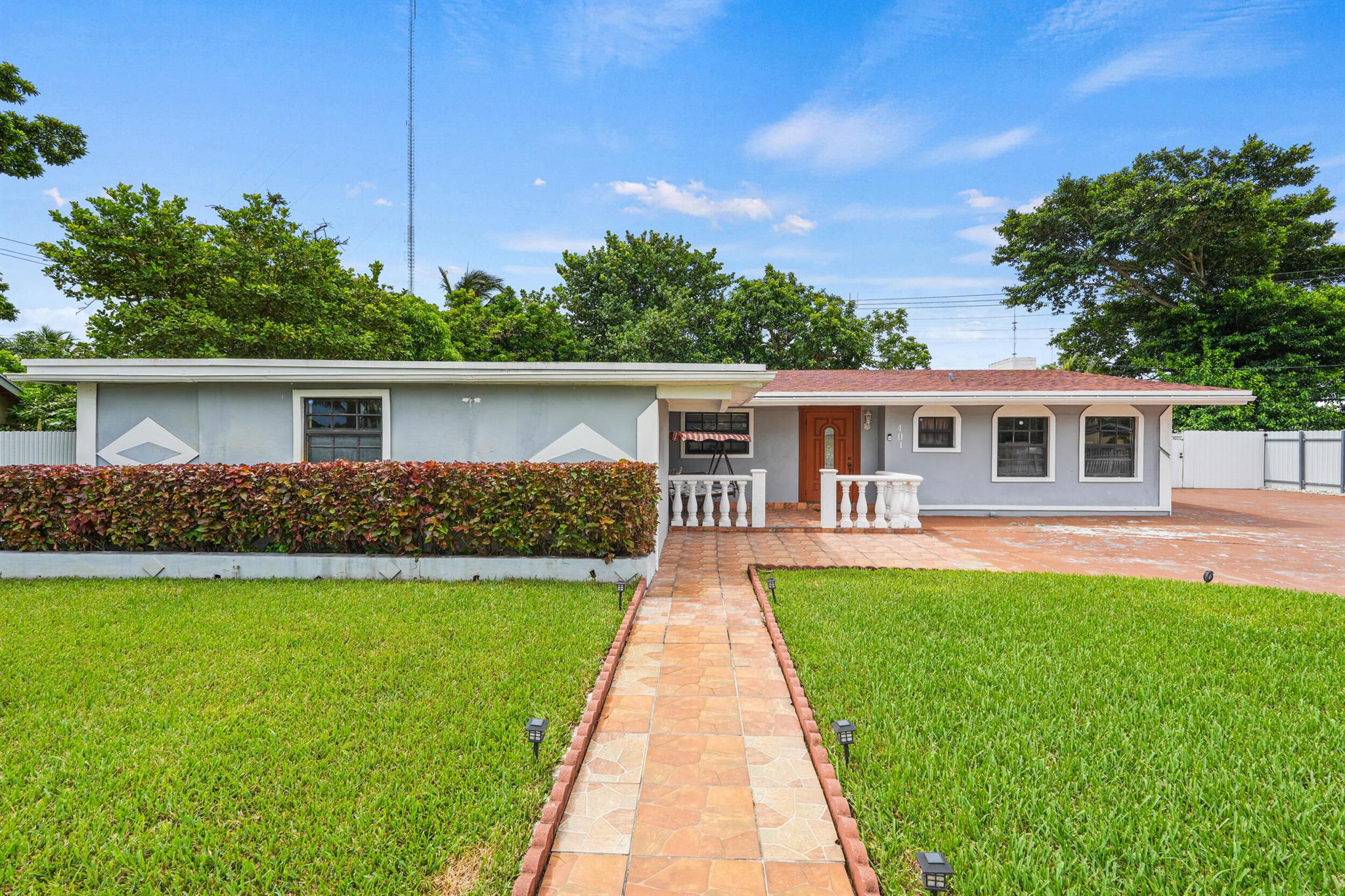 Tucked away in the quietly emerging enclave of Sierra Mirada, this hidden gem rests on an expansive, rarely found parcel that is reclusive, serene, and embraced by nature's canopy. Nestled beneath a veil of mature fruit trees that offer both privacy and a cooling reprieve from the South Florida sun, stands a proudly owned mid-century ranch exuding charm, character, and quiet sophistication. Spanning nearly 2,000 square feet, this thoughtfully updated residence strikes the perfect balance between modern comfort and timeless appeal. Bathed in natural light and designed for effortless flow, every detail has been tastefully curated and lovingly maintained, offering space, flexibility, and the potential for future expansion. A truly rare offering, this home boasts three spacious bedrooms and