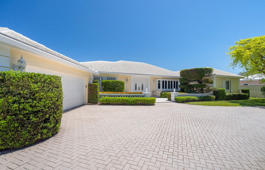 Bermuda inspired charm meets true coastal exclusivity in the gated Village of Sea Ranch Lakes—one of Florida's most private, police protected enclaves with its own oceanfront Beach Club. Cherished by the same family for decades, this elegant home offers grand flowing living spaces, forever views of Lake Cayuga, Italian marble, warm wood floors, a gourmet kitchen with Butler's Pantry, split bedrooms, full house generator, over-sized pool w/sun shelf and A/C garage. A rare opportunity to shape a legacy property in a community where 24/7 private police create a level of safety so complete that children can roam freely, with a members only Beach Club, playground, and private beach access just moments from fine dining and shopping.