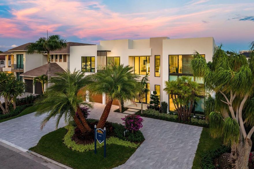 Welcome to 2240 Date Palm Road, a striking new construction estate by Primo Construction set within the prestigious Royal Palm Yacht & Country Club. The inviting five-bedroom estate has an elevated, organic, modern aesthetic; the interiors embrace natural materials, warm tones, and richly textured elements, creating a harmonious living environment spanning over 6,900 square feet of impeccably curated space. The moment you enter, soaring volumes of glass and a gallery-style foyer establish the home's seamless indoor-outdoor connection. Natural light pours across wide-plank flooring and soft, layered textures, guiding you into expansive living areas anchored by a dramatic feature-wall fireplace and custom millwork. At the heart of the home, the chef's kitchen is a modern showpiece, anchored by dual sculptural islands that elevate both functionality and design. Custom cabinetry, premium appliances, and thoughtfully integrated storage create an elegant yet highly functional culinary environment ideal for cooking, gathering, and entertaining. A glass-enclosed flex space adds a sleek architectural element, perfect as a private office or creative studio.
 
Upstairs, the primary suite offers a resort-like retreat with his-and-her spa bathroomscomplete with a luxurious saunaalong with boutique-style dressing spaces and a serene sense of privacy. Additional guest suites are equally well-appointed, each offering generous proportions, refined finishes, and a calm, modern ambiance.
 
Outdoors, the estate is a private sanctuary with a custom heated pool and spa and beautifully landscaped grounds, designed for year-round enjoyment. Whether hosting gatherings or unwinding in quiet solitude, this exceptional residence elevates daily living with its thoughtful design, sophisticated craftsmanship, and serene modern aesthetic.