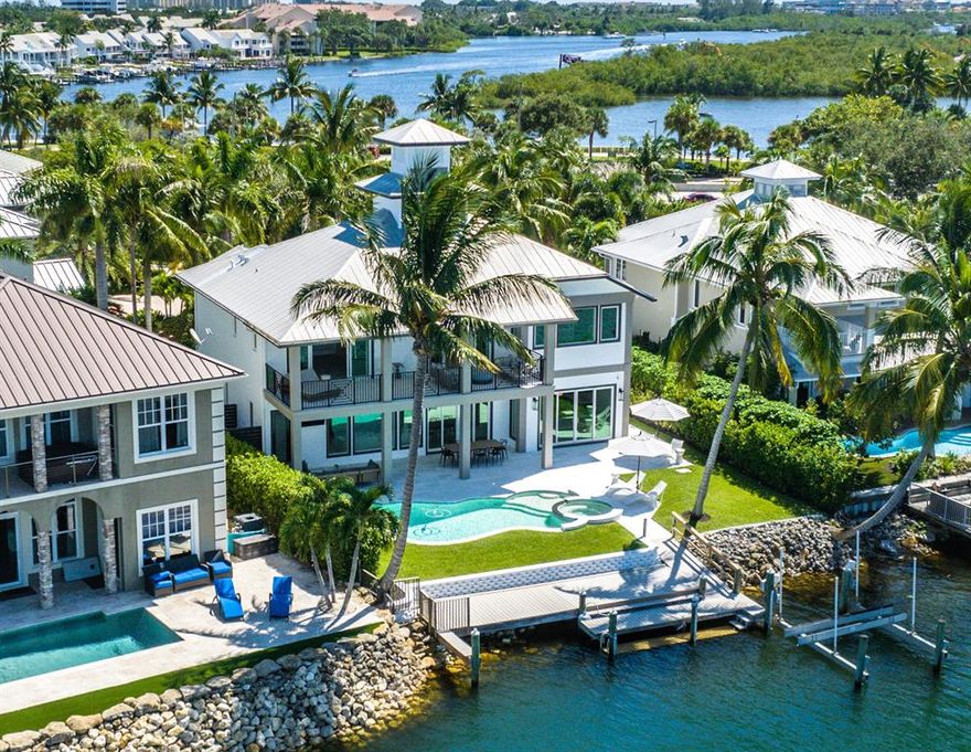 Lands End is a private gated riverfront enclave of only 8 homes. This Key West Style waterfront home has been masterfully reimagined, redesigned and totally reconstructed down to the studs adding 532 square feet to the living area.  This location is one of the few areas that have the Caribbean turquoise blue waters of the Loxahatchee River and unobstructed panoramic views.  The Jupiter Inlet is only minutes away. Enjoy exceptional sweeping water views from almost every room. Some of the many features include volume ceilings, impact windows & sliding doors providing sweeping wide river views, extensive custom cabinetry, built-ins, and the highest quality appliances throughout.