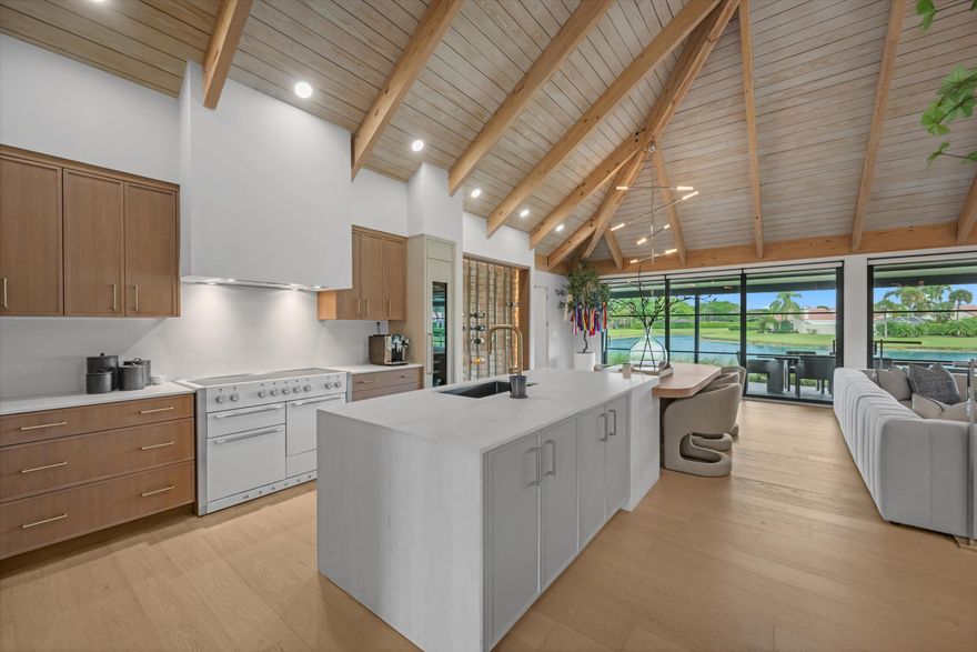 Tucked within the sought-after Palm Beach Polo community, this fully renovated 3-bedroom, 3-bathroom bungalow offers a refined blend of modern design and effortless indoor-outdoor living. Designed by Soco Interiors and offered fully furnished, the home is move-in ready with a clean, cohesive aesthetic throughout. Vaulted wood-beamed ceilings create a warm architectural statement, while wide-plank flooring and soft neutral tones enhance the light-filled, open layout. The kitchen is both functional and beautifully finished, featuring custom cabinetry, premium appliances, and a generous island that flows into the main living area. Expansive sliders open to a covered patio with wide water views. Outdoors, a private pool and thoughtfully landscaped grounds create a polished, low-maintenance setting. Additional highlights include a one-car garage and a prime location within one of Wellington's most desirable communities, just moments from the equestrian venues, dining, and shopping.