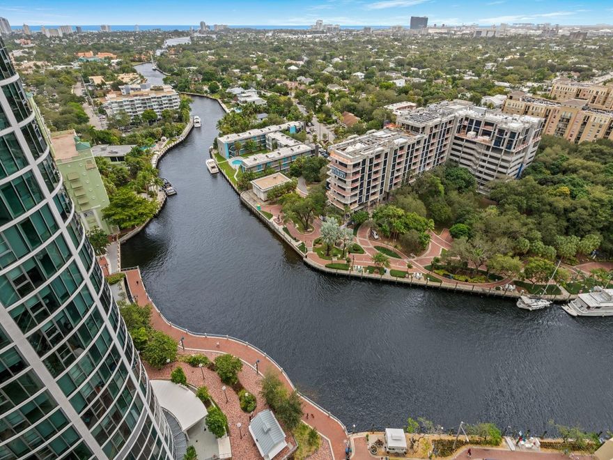 This 3 bedroom, 3 bathroom condo features sweeping vistas of the New River, ocean and skyline showcased from nearly every room. Floor-to-ceiling windows flood natural light through over 2600 sqft accentuating rich wood floors and picturesque water views. Beautifully appointed kitchen with Sub-Zero and Miele appliances, quartz countertops, and floor-to-ceiling glass-front cabinetry. Wellness amenities include a Finnish sauna and a soaking tub with captivating views. Bedroom suites offer elegant finishes, abundant closet space and balconies. Two garage spaces. Las Olas Grand features 5-star amenities including concierge service, valet and garage parking, fitness center, heated pool and spa, and social spaces — all steps from Las Olas Blvd’s shopping, dining, and cultural attractions.