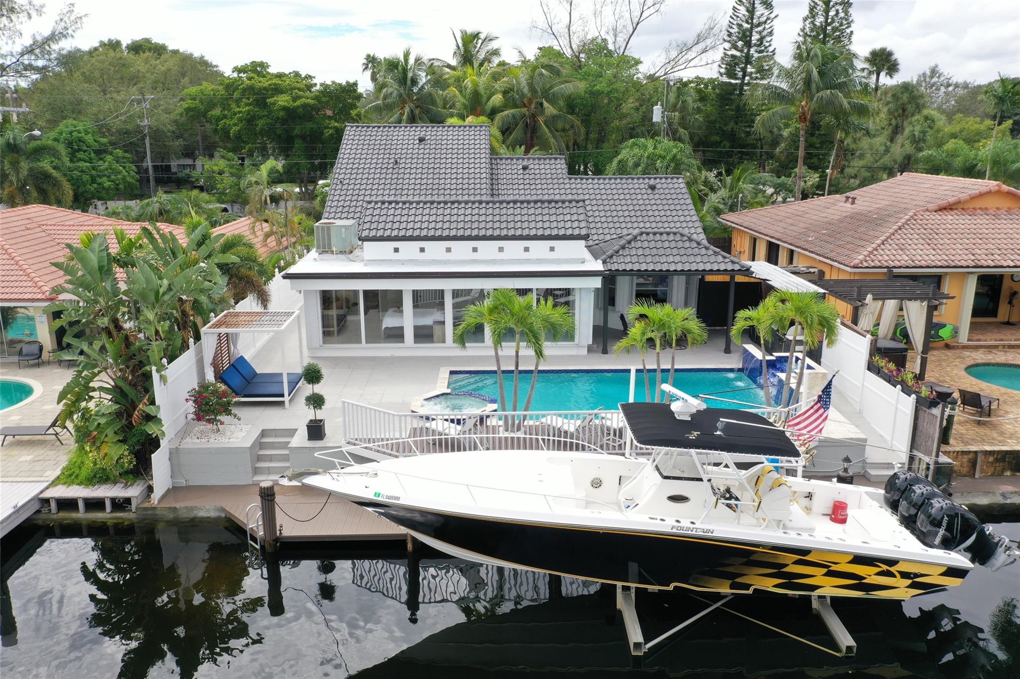 WOW!! FABULOUS REMODELED CONTEMPORARY 4 BEDROOM 4 BATH POOL HOME ON DEEP WATER UNRESTRICTED OCEAN ACCESS WATERWAY WITH NO FIXED BRIDGES. LARGE CUSTOM KITCHEN WITH NEW QUARTZ COUNTERS, PORCELIN MARBLE FLOORS, NEW STAINLESS-STEEL APPLIANCES, NATURAL GAS HOUSE GENERATOR, WATER HEATER AND POOL HEATER. NEW SUMMER KITCHEN WITH THE LUSH TROPICAL LANDSCAPED YARD, SALTWATER POOL WITH WATERFALL AND JACUZZI!! 20,000 LB BOAT LIFT ON THE 60FT DOCK!