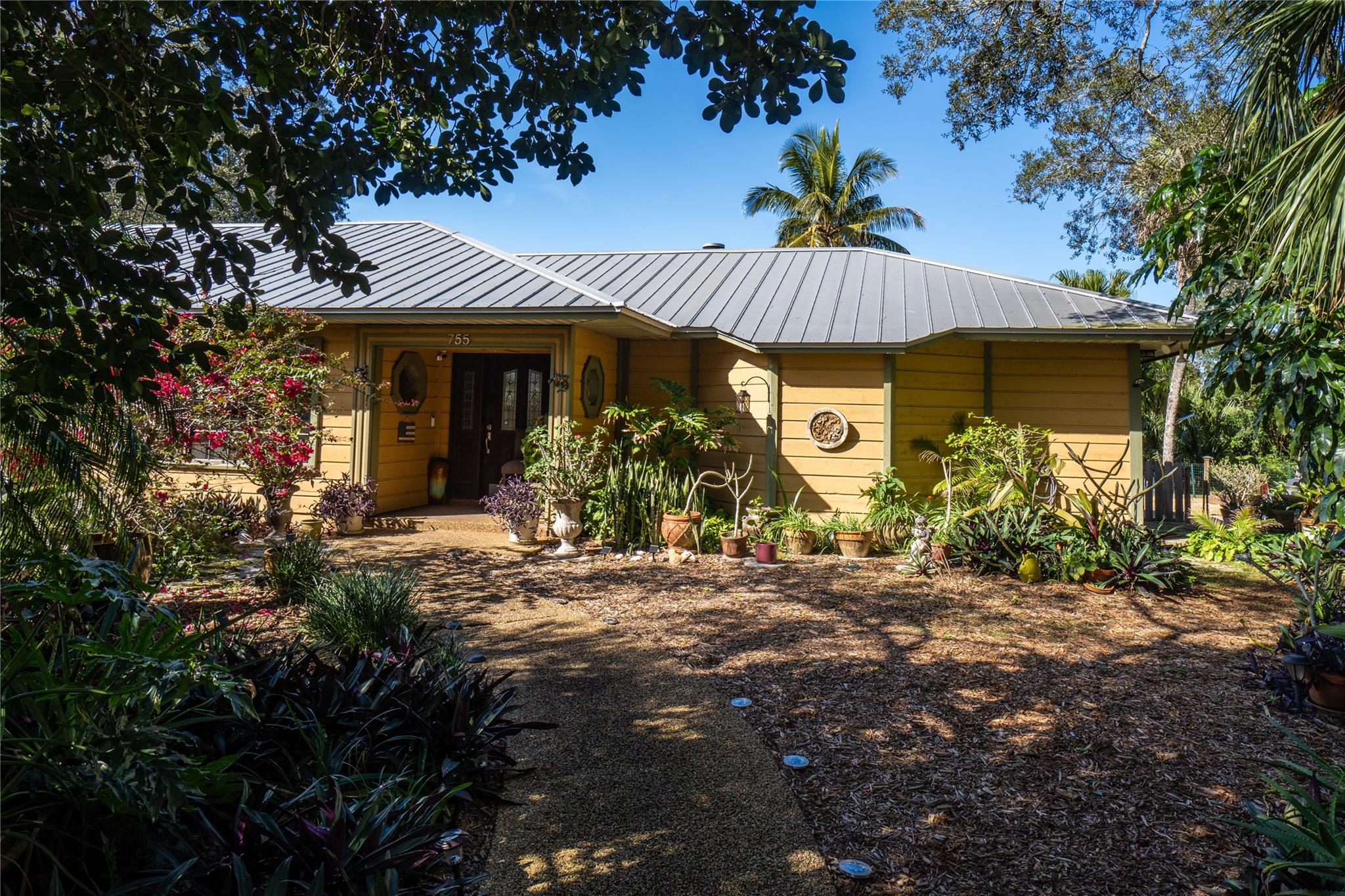 Welcome to this custom-built salt water pool home that has over 3,100 sq ft & sits on a beautiful lake in the small community of South Moon Under. With over an acre, this unique home has a large workshop with power, 2 sheds, a 3-car garage with a separate A/C/heat system that is finished with insulation & drywall, 2 fireplaces & a metal roof. Great views of the lake with glass French doors & windows that open to a large screened-in lanai. Lots of natural light & mature landscape that give undivided privacy to the home. Lots of RV/boat storage.