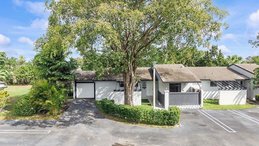 Beautifully maintained 2-bedroom, 2-bath end-unit villa offering 1,191 SF of living space plus a spacious 260 SF lanai on an oversized lot for added privacy. Features include brand-new floors, a private garage with additional parking, and abundant natural light from sliding glass doors in the living room and both bedrooms leading to the lanai. Major updates provide peace of mind: roof replaced by the HOA in 2014, HVAC (2014), and water heater (2018). The washer and dryer are conveniently located in the garage with direct access from the primary bedroom. A perfect blend of comfort, convenience, and outdoor living.