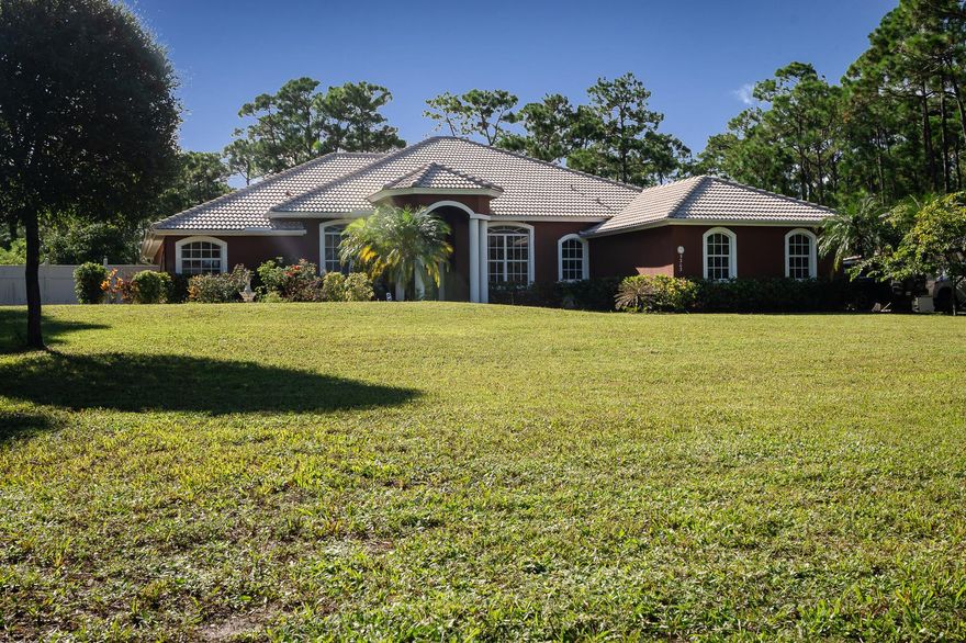 This stunning 1.15-acre retreat with NO HOA offers the perfect blend of elegance, comfort, and adventure. Designed for both family living and effortless entertaining, the home features a   Grand foyer entrance, voluminous ceiling, formal dining, formal living room, sparkling pool that invites you to relax on sunny Florida days.Mature fruit trees add both charm and functionality to the expansive property. Whether you enjoy ATVs, dirt bikes, horses, chickens, or hosting gatherings, this home accommodates it all with ease. Ideally located:3 min to stores 5 min to the boat ramp 10 min to the beach 9 min to I-95 Experience Florida living at its finest--where luxury meets adventure