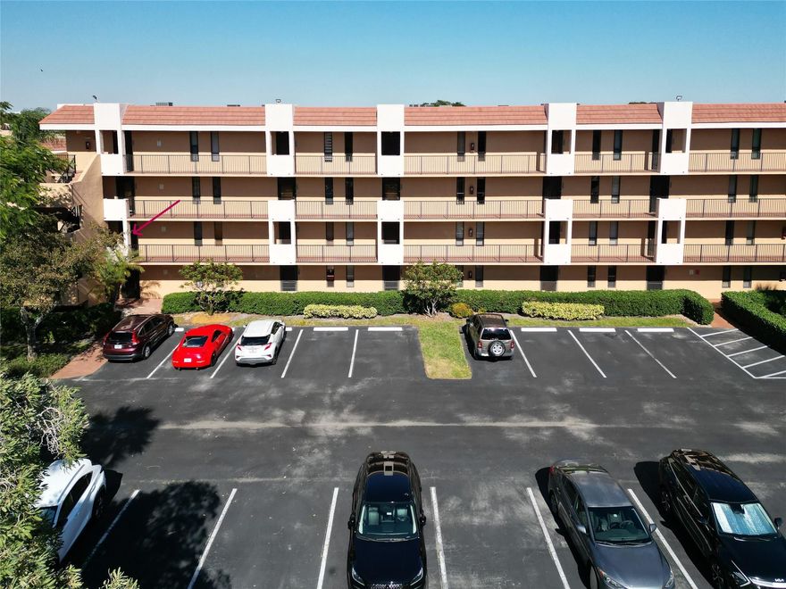 Immaculately maintained and roomy 2/2 corner unit with wide lake view looking East in Coral Gate. Large, updated kitchen with quartz counters - loads of counter space and soft-close cabinetry, plus extensive pantry and nook. Both bathrooms completely updated. Washer/Dryer in unit. Impact windows. Spotless screened balcony with Rolladen shutters overlooking a wide lake view to the East.  Knockdown ceilings and lots of natural light without West facing heat. LVP floors in entrance, kitchen & dining with carpet in bedroom and living rooms. Parking directly in front of unit. 55+ Coral Gate is non-gated, but security patrolled with two clubhouses & pools. Adjacent to Coral Gate Park with Pickle Ball & Tennis courts.