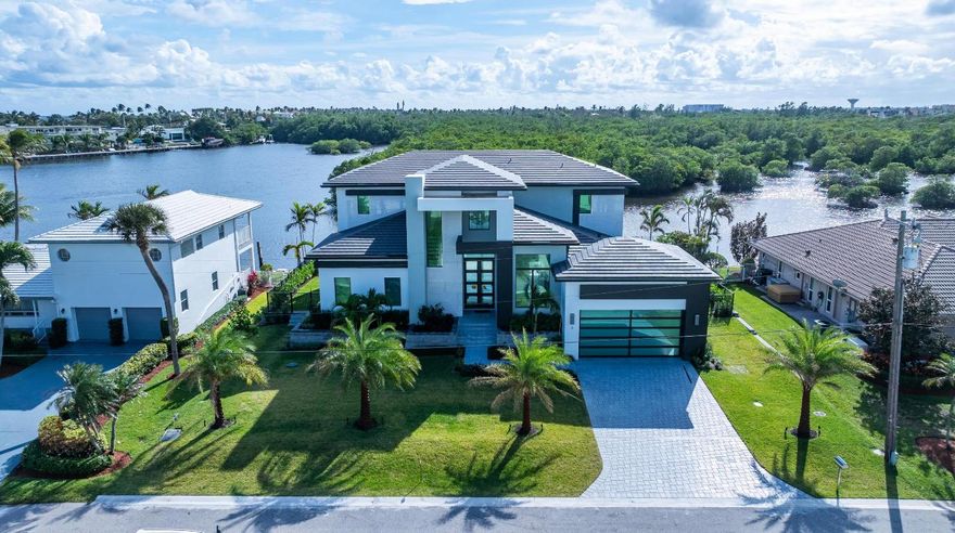 Brand new construction modern estate, on an Intracoastal Waterway island, overlooks a veritable forest of mangroves on a protected pristine nature area owned by the Town of Ocean Ridge. With 100-feet on the water and a dock, boaters will enjoy unimpeded access to the ocean. Details include a great room with a bar, great chef's kitchen, first-floor primary suite and a second-floor VIP suite. RESIDENCE:

Designed by Boca Raton architect Richard Bremer and just completed this year, with four bedrooms plus an office and 5,407 +/- total square feet, this stunning Modern estate, clad in stucco and highlighted by stone, offers the ultimate for indoor/outdoor waterfront living. Its well-conceived open-layout, split-bedroom plan  accommodates views of the water, nature area and a verdant stand of mangroves from every room. Immediately from the entry, one is transfixed. Elegant, chic, and exceedingly relaxing, details include high ceilings, window-walls of glass bathing the interiors in soft sunlight, large-format Italian porcelain flooring downstairs and engineered hardwood flooring upstairs. The two-story foyer and staircase introduce the great room, featuring a wet bar perfect for entertaining, and banks of glass sliding doors open to the poolside lanai blurring the boundary between inside and out. Just adjacent is the double-island chef's kitchen, which is fitted with handsome Shaker-style cabinetry accommodating copious storage, an artistic tile backsplash set in a herringbone pattern, and professional-grade Thermador stainless-steel appliances. The serene first-floor primary suite, set apart for privacy, comprises a spacious bedroom with sliding doors opening to the pool patio and offering water views, double custom-fitted walk-in closets and a spa-inspired bathroom with duo vanities, oversized walk-in glass-enclosed shower and a free-standing Jacuzzi tub. Upstairs, The VIP suite and two guest bedroom suites all open to the water-view balcony, with one of the guest bedrooms currently serving as an inviting club room. Completing the layout are an office, powder room, cabana bath, laundry room and two-car garage with space for car lifts.

PROPERTY:

Homeowners of this amazing estate enjoy incredible and unique views. On an Intracoastal Waterway island, the estate's south-facing fenced back yard overlooks the canal to a veritable forest of mangroves on a protected pristine nature area owned by the Town of Ocean Ridge. The treasured refuge is home a variety of Florida wildlife, a true wonder for nature lovers. Here, homeowners will also enjoy a fabulous indoor/outdoor lifestyle. The covered lanai, with a summer kitchen and grill, is just adjacent to the sun-splashed pool that integrates a sun shelf and infinity spa, set within an expansive patio. And that is not all. With a dock and 100 feet on a canal that adjoins the Intracoastal, boaters will enjoy easy ocean access with no fixed bridges.

LOCATION:

Inlet Cay Drive, Ocean Ridge, Florida. One of the Gold Coast's best-kept secrets, exclusive Ocean Ridge is prized for its quiet solitude, relaxed ambiance and unspoiled landscape nestled between the Atlantic Ocean and the Intracoastal Waterway. 

DISCLAIMER: Information published or otherwise provided by the listing company and its representatives including but not limited to prices, measurements, square footages, lot sizes, calculations, statistics, and videos are deemed reliable but are not guaranteed and are subject to errors, omissions or changes without notice. All such information should be independently verified by any prospective purchaser or seller. Parties should perform their own due diligence to verify such information prior to a sale or listing. Listing company expressly disclaims any warranty or representation regarding such information. Prices published are either list price, sold price, and/or last asking price. The listing company participates in the Multiple Listing Service and IDX. The properties published as listed and sold are not necessarily exclusive to listing company and may be listed or have sold with other members of the Multiple Listing Service. Transactions where listing company represented both buyers and sellers are calculated as two sales. "No payments made until title passes" Some affiliations may not be applicable to certain geographic areas. If your property is currently listed with another broker, please disregard any solicitation for services. Information published or otherwise provided by seller, listing company or its representatives is deemed reliable but are not guaranteed and subject to errors, omissions, or changes without notice. Copyright 2025 by the listing company. All Rights Reserved.