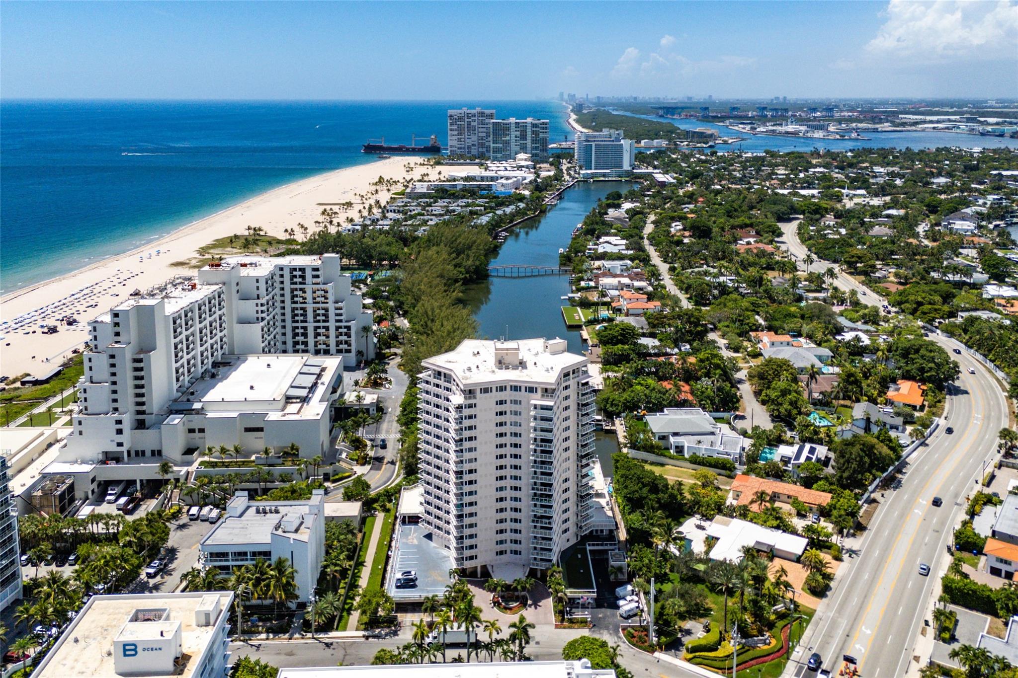 Experience coastal living at its finest in this light-filled beachfront corner unit with private balcony and breathtaking views from every room. Thoughtfully designed, it features an oversized bedroom w/ en suite bath, plus a convenient guest bath off the living area for privacy. Expansive kitchen is ideal for everyday living/entertaining. Other highlights: Walk in closet, in-unit washer/dryer, assigned covered parking, and private storage locker, heated pool, Peloton-equipped gym, 2 BBQ areas, community dock (kayak/paddleboard), bike storage, 24hr security. Pet-friendly (2 pets up to 25 lbs).Prime location—just steps to the widest stretch of Fort Lauderdale Beach, one block from Marina Village, one mile to Las Olas Blvd. Close to dining, shopping, marinas & airport and more!