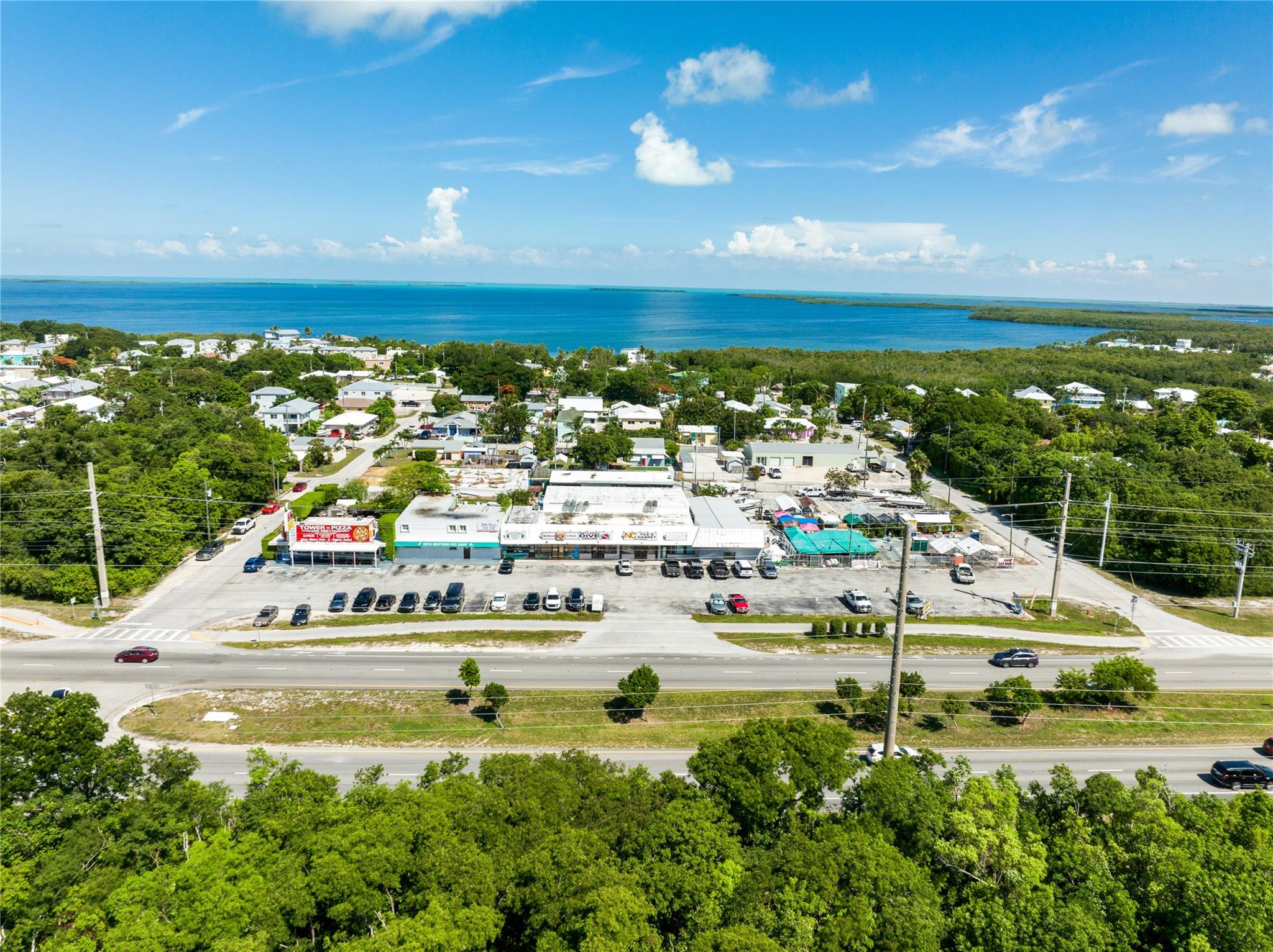 Prime commercial lot with Free-standing building in the heart of Key Largo: Storefront with an office and storage, a 3 bdr/3 bath residential apartment fully renovated on 2nd floor, patio, and rooftop, 5 parking spaces and 5 additional spaces rented.
Established iconic pet store Business (optional $250K additional!).
High visibility. strategic location right on US-1, unbeatable exposure to both tourists and locals.
The building has shutters on top of impact windows and is not in a flood area: all Concrete 15 ft about see level -structurally strong, in rebar metal and inside concrete.