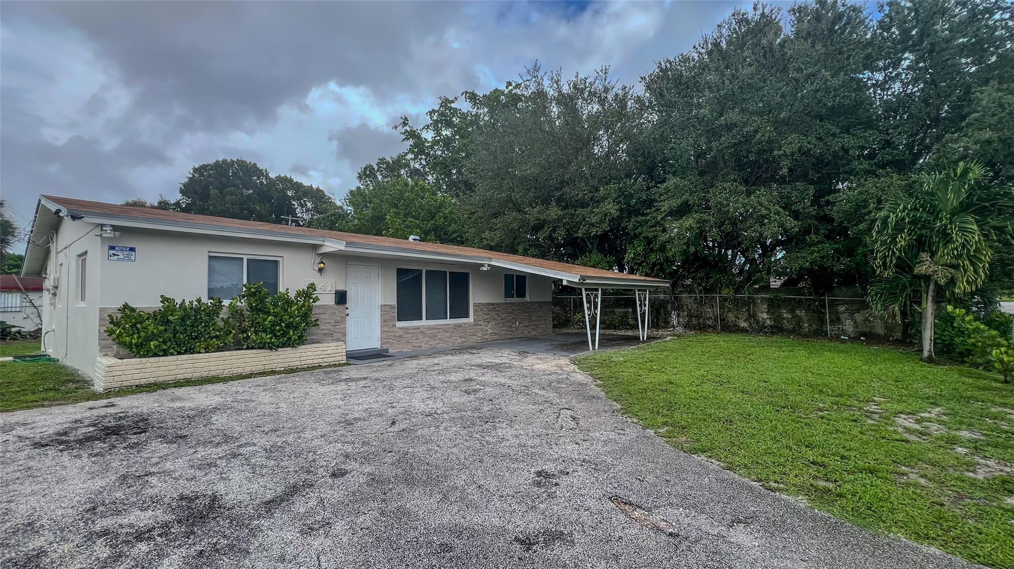 Recently renovated home with open layout, tile floors, updated kitchen and baths, and fresh paint. Large backyard  carport and driveway parking, no parking restrictions. Close to SR441, Sunrise Blvd and I95, shopping, dining and parks in The Greater Fort Lauderdale Area.