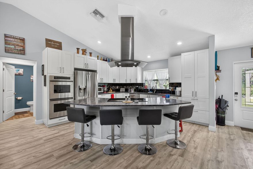 Custom-built 2019 home on 2.5 cleared acres in a quiet dead-end, surrounded by stunning equestrian estates. Split floor plan with spacious primary suite, private second en-suite, and guest room with bath access. Gourmet kitchen features quartz counters, a large island with a glass cooktop, double ovens, premium cabinetry, and 3 pantries. Smart electric, oversized 2+ car garage, large laundry with sink, covered porch, and screened patio. Plenty of room for a pool, barn, or more. Rare opportunity: neighboring property also for sale—combine for 8.5+ acres with 2 homes, 12-stall barn & 9 paddocks.