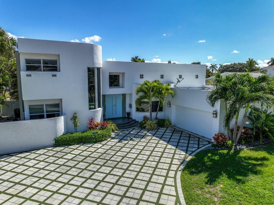 Grand pool home on a rarely available and highly sought after lot with a long water view in prestigious Lake Rogers! Only 4 lots in the community with this incredible direct view of the Intracoastal. 65' of direct waterfrontage and a 40' dock with no fixed bridges, you're only minutes from the Boca Inlet and Atlantic Ocean. Also, just a short car ride to Mizner Park, famous for incredible dining, shopping and entertainment. This light and spacious home features a new roof in 2022, garage and panel wired for level 2 EV charging, impact windows throughout, new tankless water heater, 250 ga. propane tank for the pool, fireplace, and grill, granite countertops, and beautiful custom flooring. This is the one you're looking for, priced to sell, schedule a showing today!