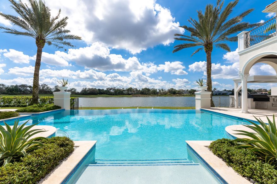 If you are looking for perfection in a home, this is it! This 6 bedroom 4.5 Car garage newly renovated home on the lake has it all! The views are breathtaking from the moment you step in the front door. Relax in your newly redone infinity pool and spa. Or sit by the outside fireplace and granite bar while watching the sunset. Enjoy use of a backyard putting green and a newly built outdoor kitchen, outfitted with lynx appliances, pizza oven, and pergola. Once inside the home the kitchen is a chefs' dream with dual islands, 2 sinks, 2 dishwashers, 2 garbage disposals, Miele ovens, expresso center, steam oven, refrigeration drawers, butler's pantry with large wine cooler, walk in pantry with custom pull outs. Every amenity you could want is in this kitchen.