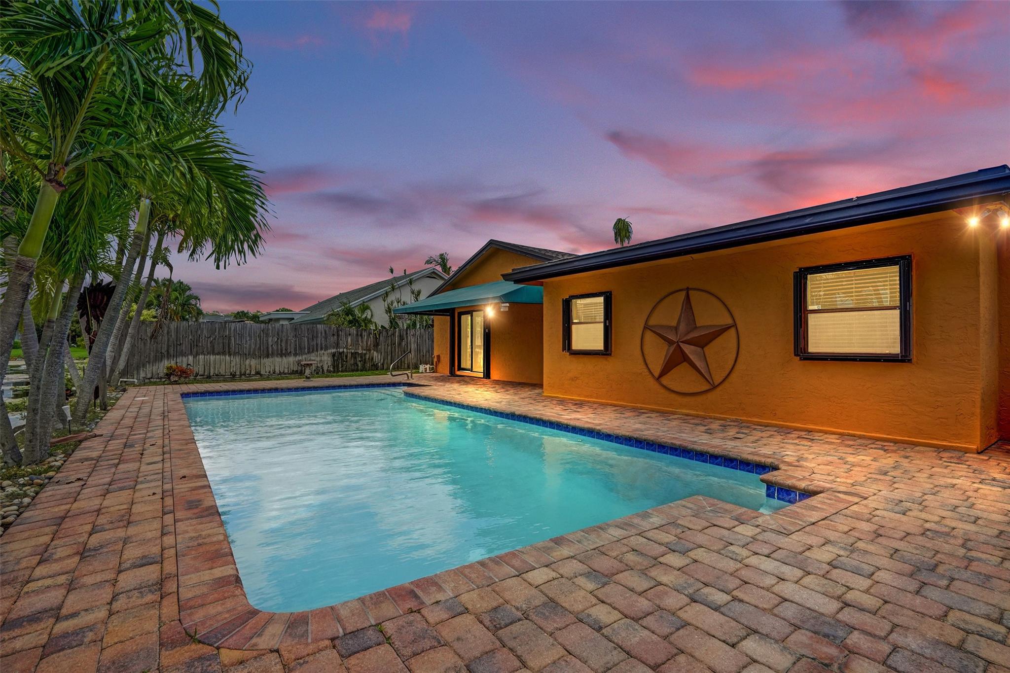 talk about checking ALL the boxes. This one wins! 4/2 with a pool and a 2 car garage, on the water. Boxes checked! Incredibly well cared for in a great community, set back and secluded. When you walk in the first thing you notice is the high vaulted ceilings. wide open space. Updated kitchen with stone counters and stainless appliances. Separate "flex" room off the kitchen, opens up to the huge pool and patio deck. The 2 car garage open right up into the kitchen for easy access. Impact rated garage door, some windows are impact rated as well. Bathrooms are updated. The bonus "pool" room is perfect for family fun. This is a quiet community with sidewalks and lots of large trees in the community.