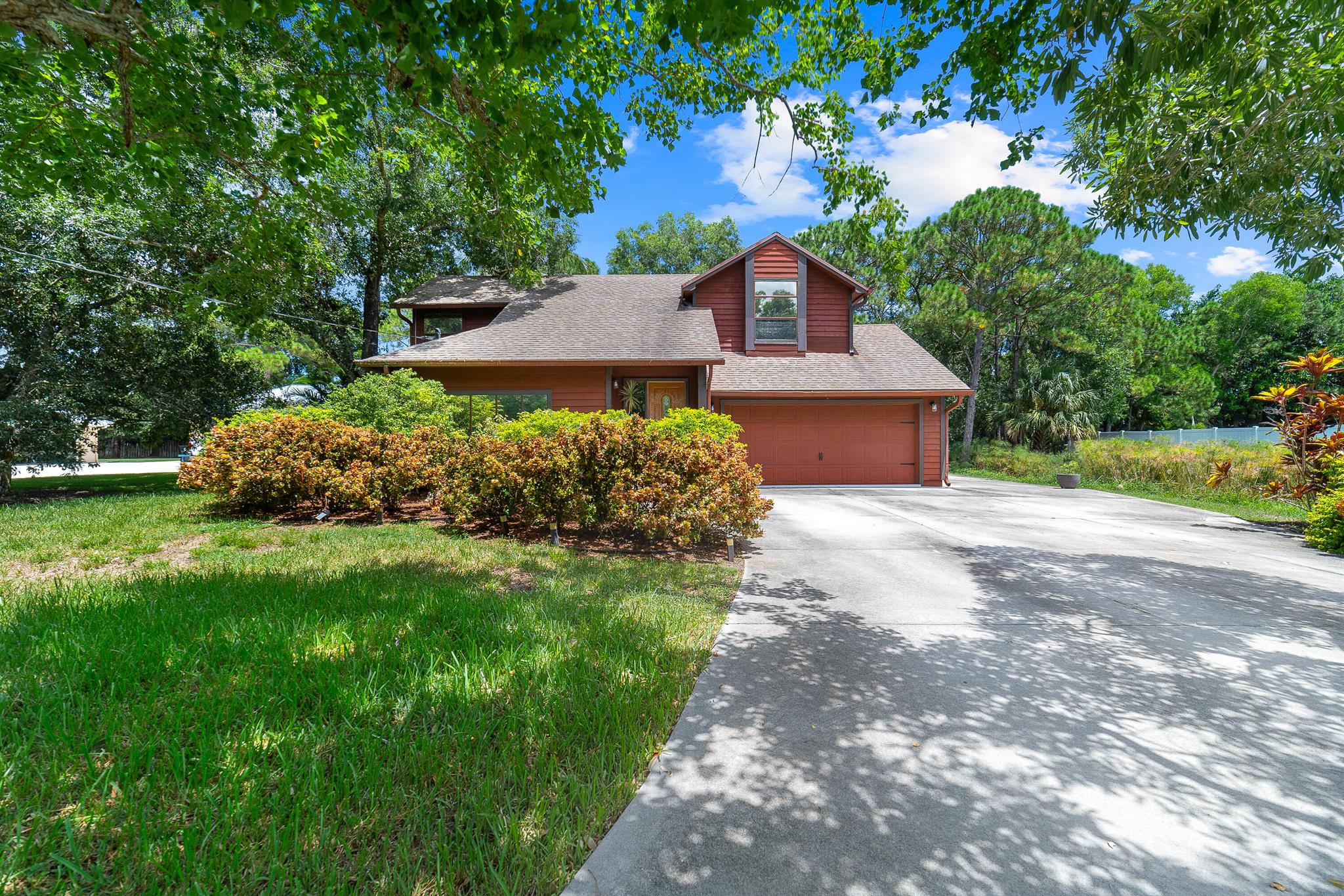 Welcome to this inviting two-story home in the sought-after Northport Village community of Port Saint Lucie. Designed for comfort and easy living, this residence features a spacious open layout that seamlessly connects the living areas, creating an ideal setting for both everyday living and entertaining.Step outside to your own private tropical retreat, where lush palm trees frame a tranquil koi pond and a gentle stream runs along the side of the property. The screened-in back patio, complete with a relaxing jacuzzi, offers the perfect spot to unwind or host gatherings while enjoying the serene surroundings.Practical updates include a new AC and a new water heater, both installed in 2022. The property also features dedicated parking on the south side of the home, ideal for those