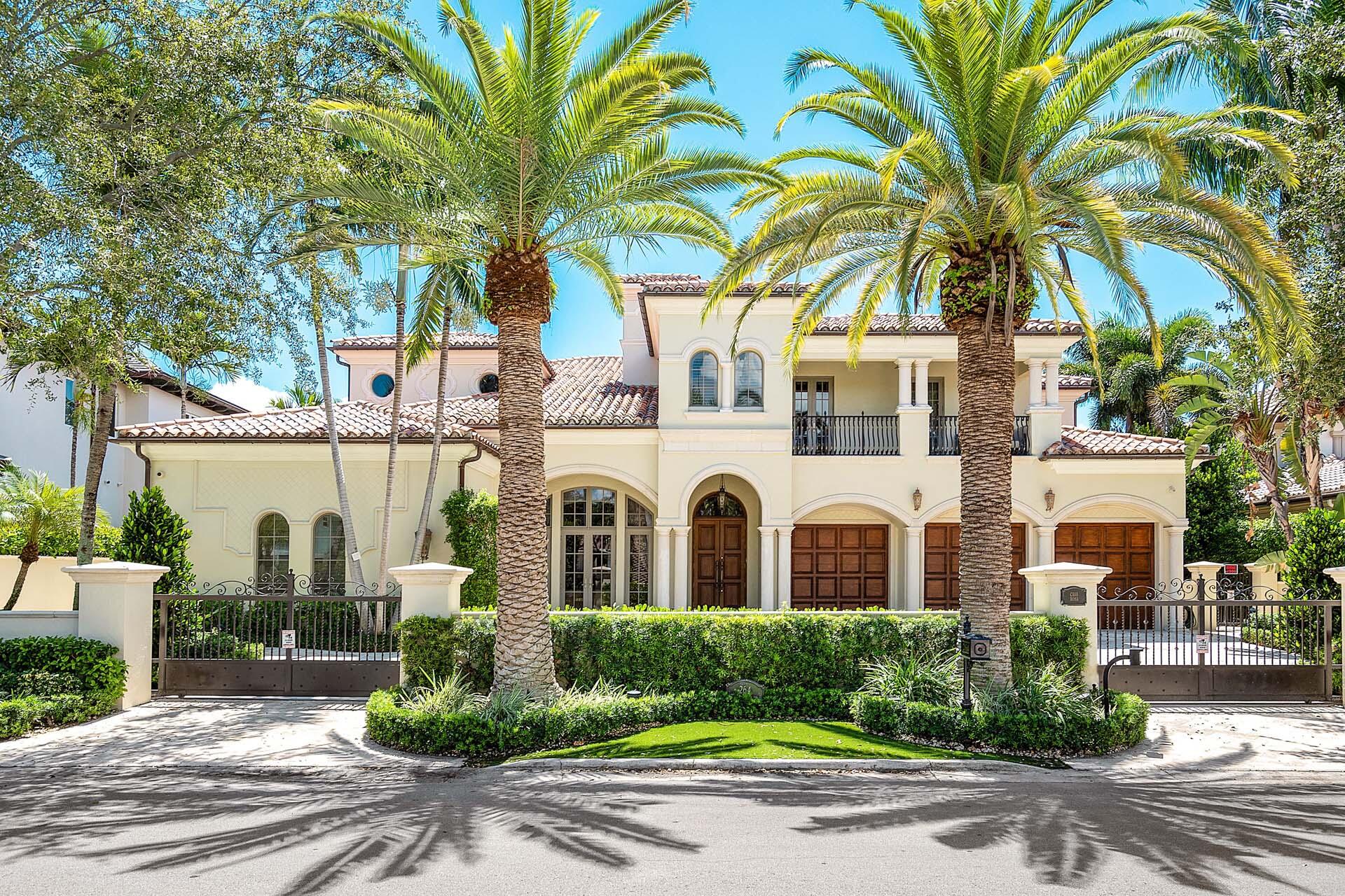Casa Rosa is a grand waterfront estate located on 112' of the most expansive waterway in Royal Palm Yacht & Country Club. Set behind a gated motor court with pristine tropical grounds, this remarkable 7,900+ sf estate was imagined by Benedict Architecture and garnished with designer finishes by Marc Michaels Interiors. From the imported Portuguese limestone floor to the generous hand-carved trim, there were no details overlooked. The 5-bedroom, 6.1-bathroom home offers an oversized chef's kitchen, home theater, handsome clubroom, private study, 3 fireplaces, elevator, and spacious second-floor lounge. The main suite enjoys waterway views from the covered balcony, a massive suite with sitting areas, and beyond the foyer reception are His & Her spa-like bathrooms with boutique closets.