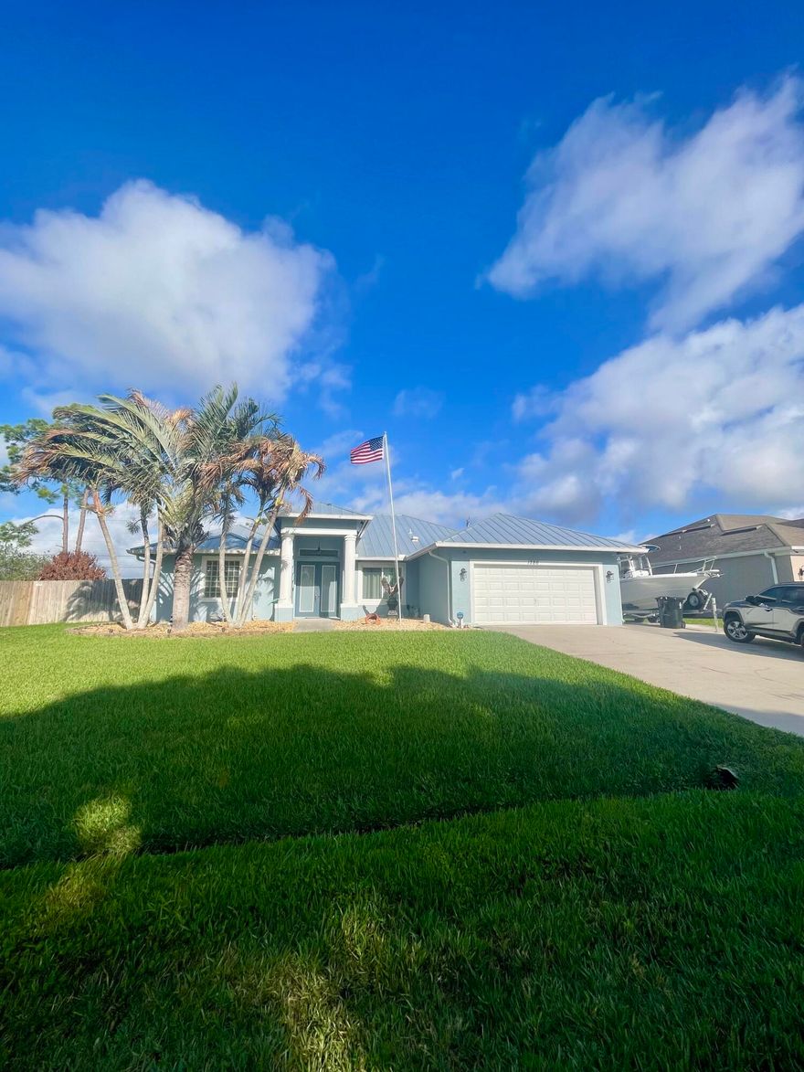 Shows like a model. Absolutely immaculate custom  home with large pool and adjoining spa .Adjacent lot in back also available that totals over 1/2 a acre. (MLS #B26002644) Has a newer metal roof (2022) ,impact glass windows , newer hot water heater, impact french doors with two entries to backyard pool. remodeled kitchen with quartz counters and custom backsplash. Garage equipped with multiple cabinets and backyard has storage shed. Yard is equipped with sprinkler system and Floratam grass. OVERSIZED yard and has a 3 car paved Driveway , Fenced yard and superb location next to Tradition and PGA west of I-95.