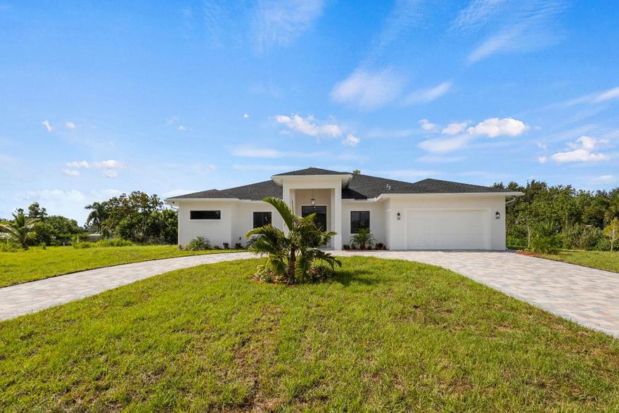 Brand-new CBS home with a two-car garage on 1.19 acres in the heart of Loxahatchee! This 4-bedroom, 3.5-bathroom residence features an open, modern layout with vaulted ceilings, porcelain tile flooring, and impact-rated doors and windows.
The gourmet kitchen boasts wood cabinetry, quartz countertops, a large island, oversized pantry, and brand-new stainless steel appliances. The luxurious master suite includes a Roman tub, separate shower, dual vanities, and his-and-her walk-in closets with custom-built shelving. The expansive lot provides exceptional versatility, allowing you to bring in your boat, RV, trailer, or trucks, raise animals such as horses, or even build a guest house, workshop, or large structure. The backyard is extremely spacious, providing plenty of room for a pool, and includes a large open patio with a built-in sink and barbecue area, perfect for outdoor entertaining. Conveniently located minutes from Lion Country Safari, Westlake, Avenir, shopping, dining, and Florida Turnpike. Don't miss this opportunity to call this gorgeous property your "home."