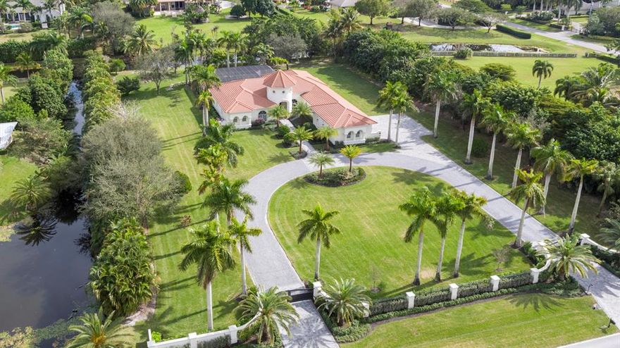 This gorgeous Wellington custom estate home was just updated in 2020 with over $1M in renovations and additions. The home is settled on just over 2 acres and is nestled in the heart of the equestrian area. This modern home includes 4,750 square foot under air, 5 bedrooms, 4.5 baths, 3 car garage, and a screened in pool with spa and outdoor kitchen.  New updates include a brand new custom gourmet kitchen with oversized island, all new top of the line appliances including Liebherr oversized refrigerator and freezer columns, Viking gas pro cooktop, Viking double oven, Liebherr full size wine refrigerator, under-counter slide out microwave and custom built-in full size pantry.  The amazing 9ft x 24ft wide stackable sliding door system opens directly to the updated extra large and deep pool